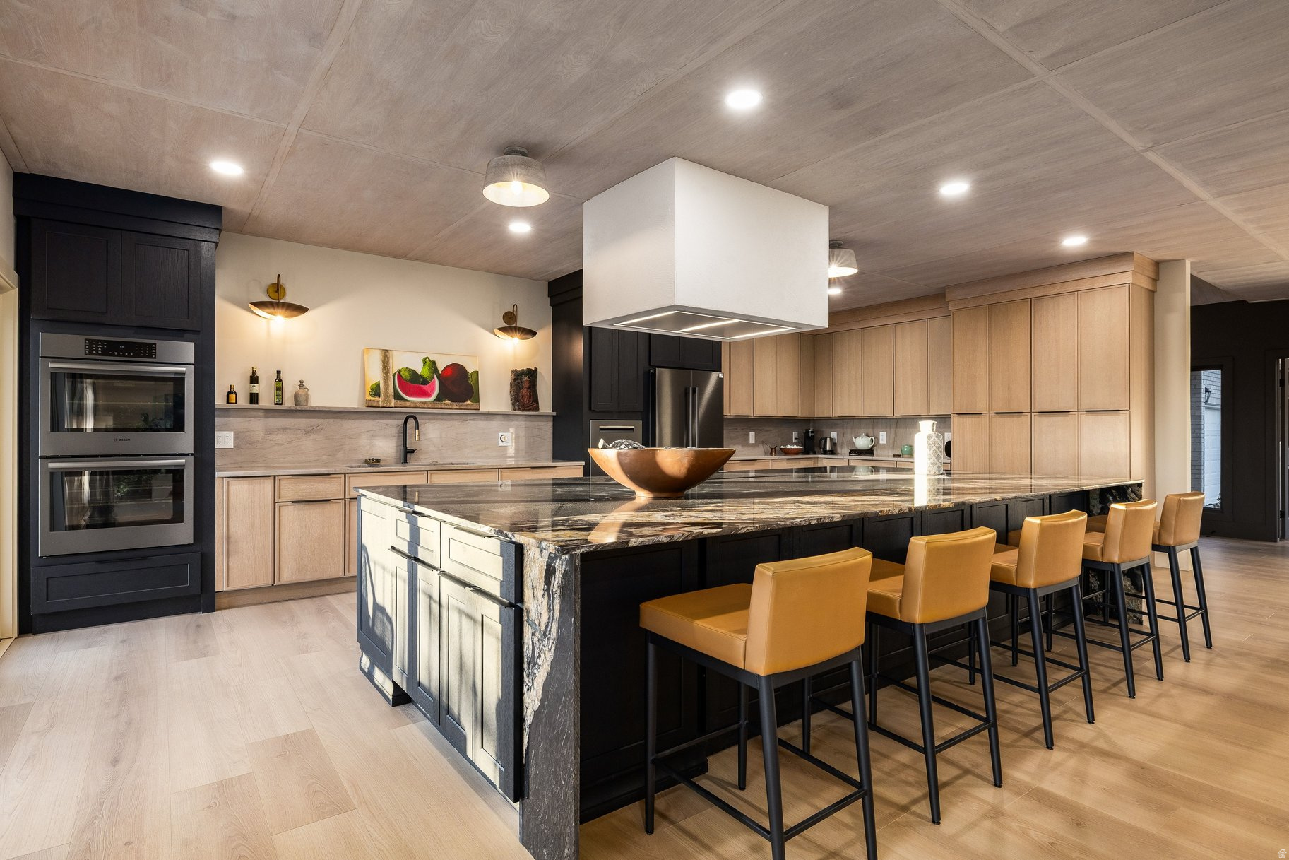 **Open house, Saturday June 13th 9am-11am** Gutted to the studs and expertly completed through the HOA approval process by one of SLC's Parade of Homes designers, this Upper Avenues townhome is a rare find - single-level living, an oversized built-in two-car garage, and finishes so thoughtfully curated you'll feel them before you can name them.Wood-paneled ceilings. Heated bathroom floors. Hand-selected stone and light fixtures. A primary suite with an oversized steam shower and soaking tub wet area that genuinely impresses. Every detail here was chosen with intention.The main level was made for living: a massive entertaining island anchors the open kitchen, a mudroom with dog wash keeps life organized, and a flexible second room works equally well as an office or guest space. Downstairs, two ensuite bedrooms offer privacy and comfort, alongside a secondary entertaining zone with gaming, a full wet bar, and a pre-plumbed sauna and cold plunge gym room with rubber flooring and a second washer/dryer. This isn't a bonus space - it's a whole second lifestyle.