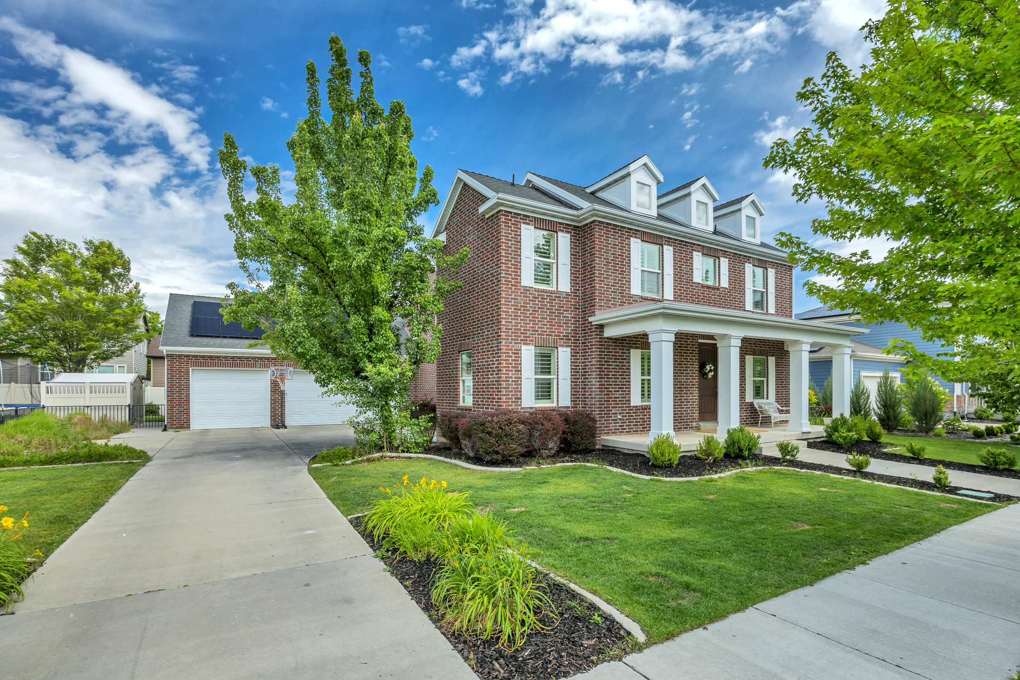 Beautiful and time-less all-brick two-story home located on a charming tree-lined street in the heart of Daybreak. Offering over 5,000 square feet of living space, this home features 6 bedrooms, 4.5 bathrooms, a dedicated main-floor office, and a spacious 3-car garage.  Inside, you'll find hardwood floors, cherry cabinets, granite countertops, and a well-appointed kitchen with all appliances included (refrigerator, washer and dryer). The open layout provides plenty of space for both everyday living and entertaining.  The mature trees and landscaped yard create a welcoming outdoor setting, while Daybreak's incredible amenities are just outside your door. Enjoy access to five community pools, Oquirrh Lake, over 50 miles of walking and biking trails, pickleball courts, parks, and year-round community events.  This is a rare opportunity to own a spacious, well-maintained home in one of Utah's most sought-after Daybreak streets.  Square footage figures are provided as a courtesy estimate only and were obtained from previous appraisal/ listing.  Buyer is advised to obtain an independent measurement.