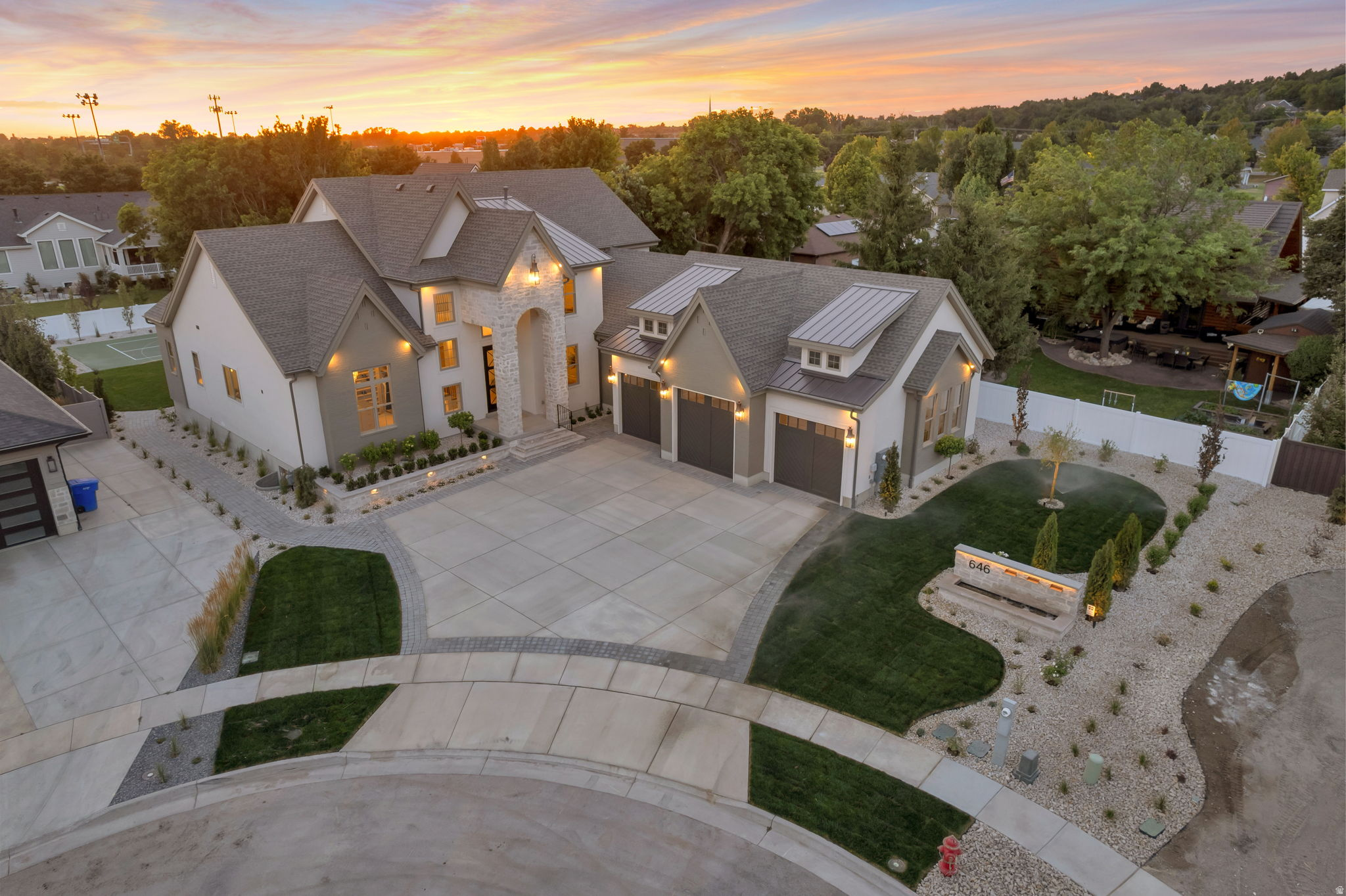 Welcome to over 7,300 square feet of extraordinary craftsmanship in the heart of Farmington in a quiet cul-de-sac. This stunning modified 'Timpani' plan from local renowned builder has a lot of "wow" factor, starting with the curb appeal and address marquee/water feature. Soaring two-story ceiling with a wood beam grid ceiling, a dramatic floor-to-ceiling fireplace wall, and a chef's kitchen create an entertainer's dream on the main level. Kitchen boasts top-of-the-line appliances, a second island bar, and a butler's pantry/prep kitchen complete with a sink, dishwasher, and 2nd fridge. Custom "pocket office" adjacent to the greatroom. Main level owner's suite on one wing of the home has a spa-like bathroom with his-and-her vanities, a freestanding soaking tub, oversized custom digital shower, and in-suite laundry in the wardrobe room that feels more like a boutique. Every one of the six bedrooms enjoys its own private ensuite bath and a walk-in closet. The upper floor offers three bedrooms with ensuites and a dedicated laundry room. The lower level delivers two additional ensuite bedrooms, a third laundry room, full kitchenette, home theater, and private gym. Adjacent to the finished and heated three-car garage, a private golf simulator lounge with wet bar and sophisticated finishes brings the course home in style. Step outside to a covered outdoor kitchen, fire pit seating area, pickleball court, and custom storage shed to match the home - all set against Utah's stunning mountain backdrop. Built by Symphony Homes - Utah's premier semi-custom builder with over 30 years of award-winning craftsmanship. This is not just a home. It is the life you have been building toward.