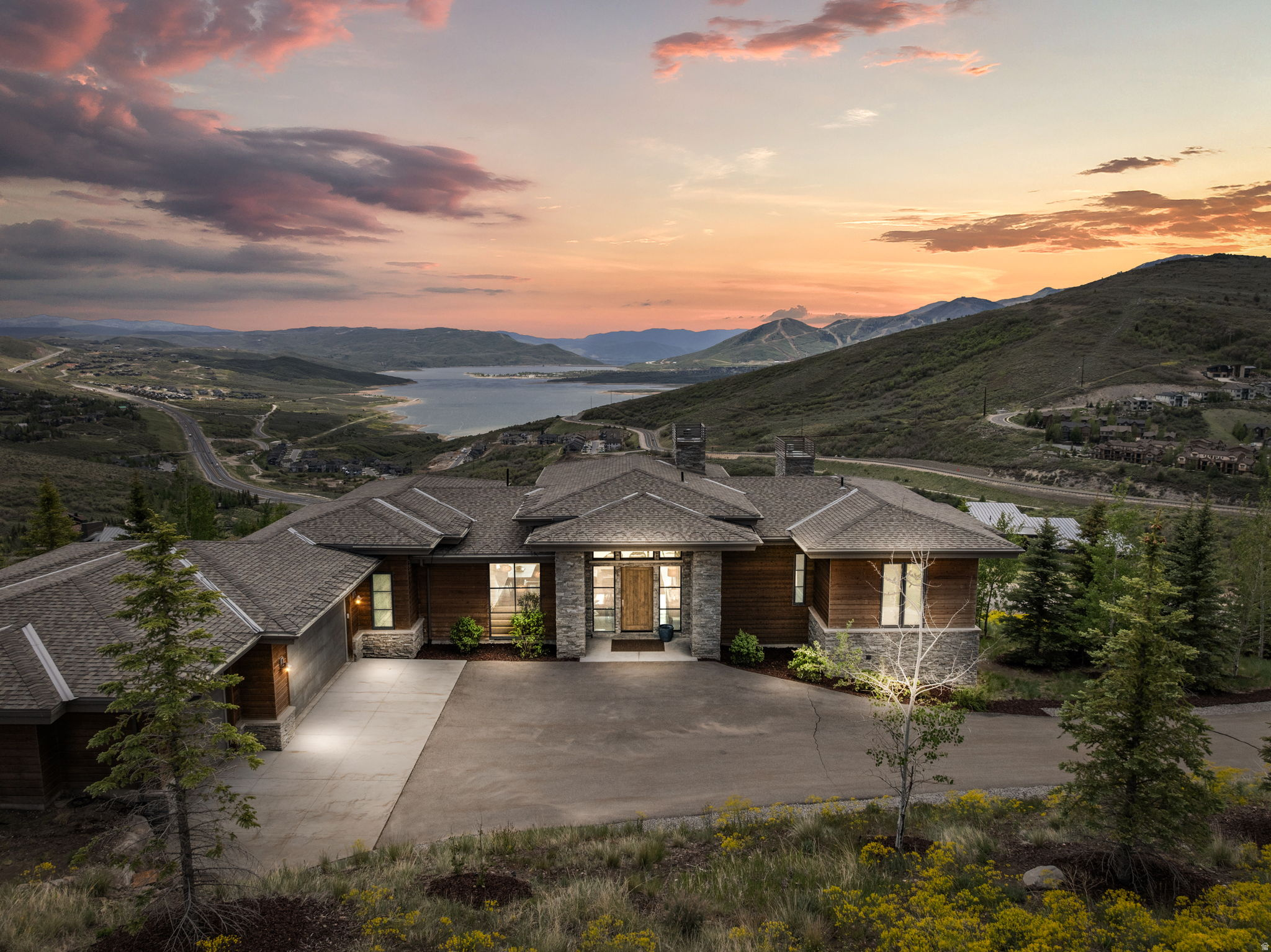 Located within the private gated community of Deer Vista on a 1.38-acre lot, this exceptional 4,850 sq ft mountain retreat was featured in the 2020 Home Show and showcases breathtaking panoramic views of Jordanelle Reservoir and Deer Valley. Designed to maximize the stunning scenery, the home features expansive windows throughout, filling the space with natural light and seamlessly blending indoor and outdoor living. The home layout offers 4 spacious bedrooms, each with its own private en-suite bathroom, including a luxurious main-level primary suite. This home combines comfort, functionality, and elevated mountain living, complete with modern smart home features and a relaxing hot tub perfect for enjoying the surrounding mountain views. Enjoy the privacy and exclusivity of Deer Vista while being just minutes from Jordanelle Reservoir, Deer Valley East Village, and Historic Park City Main Street, providing year-round access to world-class recreation, dining, and entertainment.