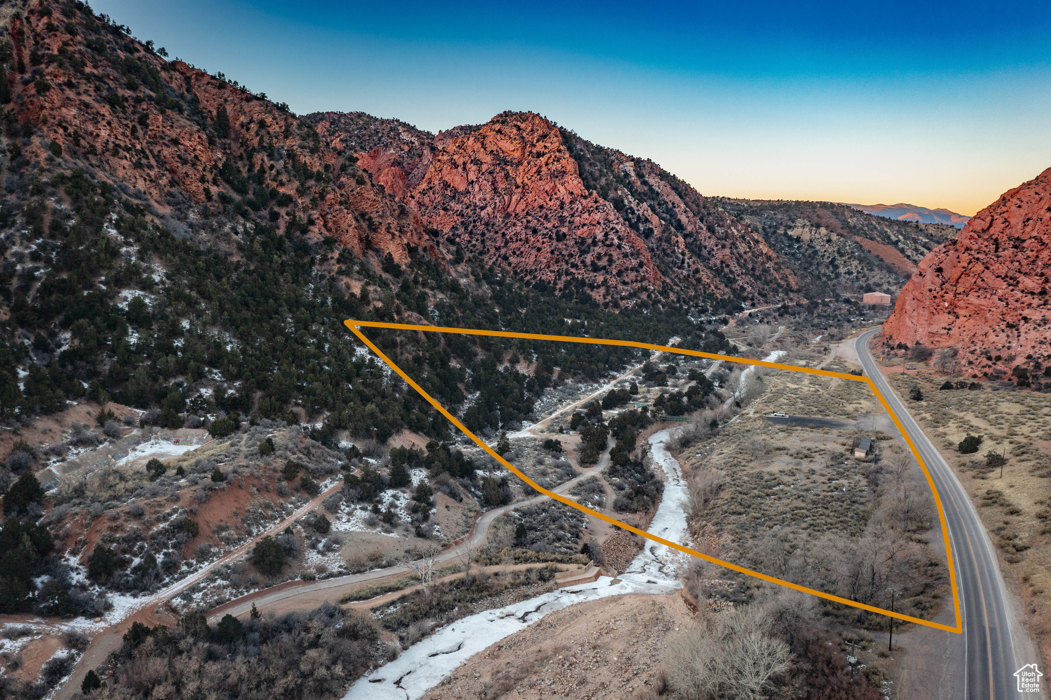 This property offers a rare opportunity for potential subdivision in one of the most unique and picturesque areas of Southern Utah. With level areas primed for development, the location provides convenient highway access and is equipped with a variety of amenities. A parking lot, a walking bridge crossing the scenic creek, and a waterfall creates a welcoming environment for visitors. Additional features include tranquil sitting areas, a walking path perfect for leisurely strolls, and restrooms with running water for added convenience. Zoned R-1, this site holds immense potential for future projects. All proceeds from this property will benefit the Southwest Wildlife Foundation, making this not only an excellent investment but also a meaningful contribution.