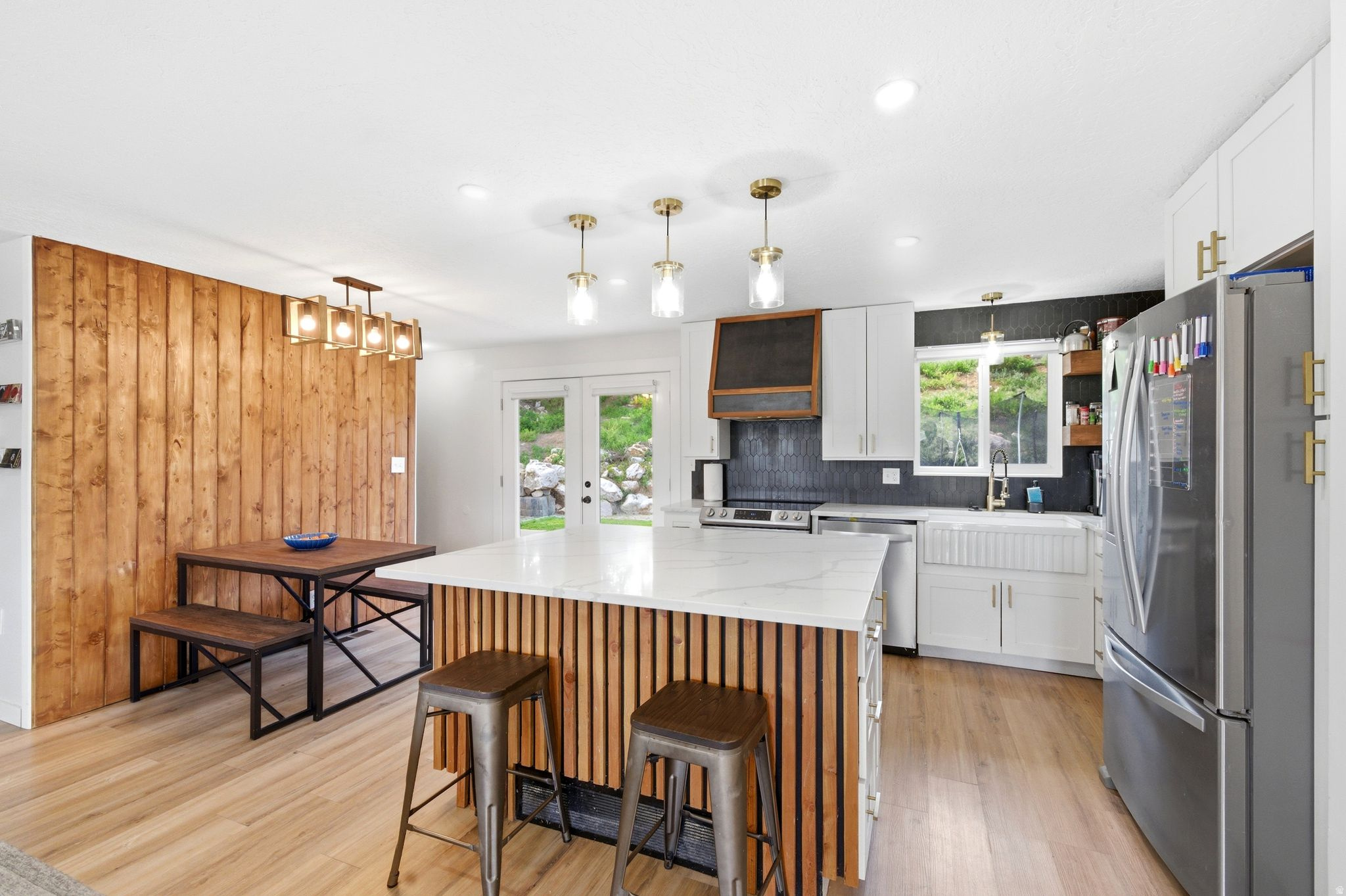 *Professionally cleaned top to bottom* Completely remodeled and move-in ready, this Riverdale home offers 5 bedrooms, 3 bathrooms, and over 2,200 square feet of thoughtfully updated living space on a spacious 0.23-acre lot. The main level features a bright, open layout centered around a fully renovated kitchen with quartz countertops, custom cabinetry, stylish finishes, and a large island designed for gathering, all flowing seamlessly into the inviting living area with a cozy fireplace and built-in shelving. Throughout the home you'll find custom touches that set it apart, including hidden Murphy beds and flexible spaces perfect for guests, a home office, or multi-use living. The lower level provides additional room to relax or entertain, while the backyard truly steals the show with a large deck, pergola seating area, terraced landscaping, and plenty of space for kids, play, and outdoor enjoyment. Major system updates add peace of mind, including a new A/C (2022), new sewer line (2023), new roof (2024), and new water heater (2025). Tucked on a quiet street with quick access to shopping, dining, parks, and freeway access, this home offers the perfect combination of location, upgrades, and lifestyle. Buyer and buyer's agent to verify all information.
