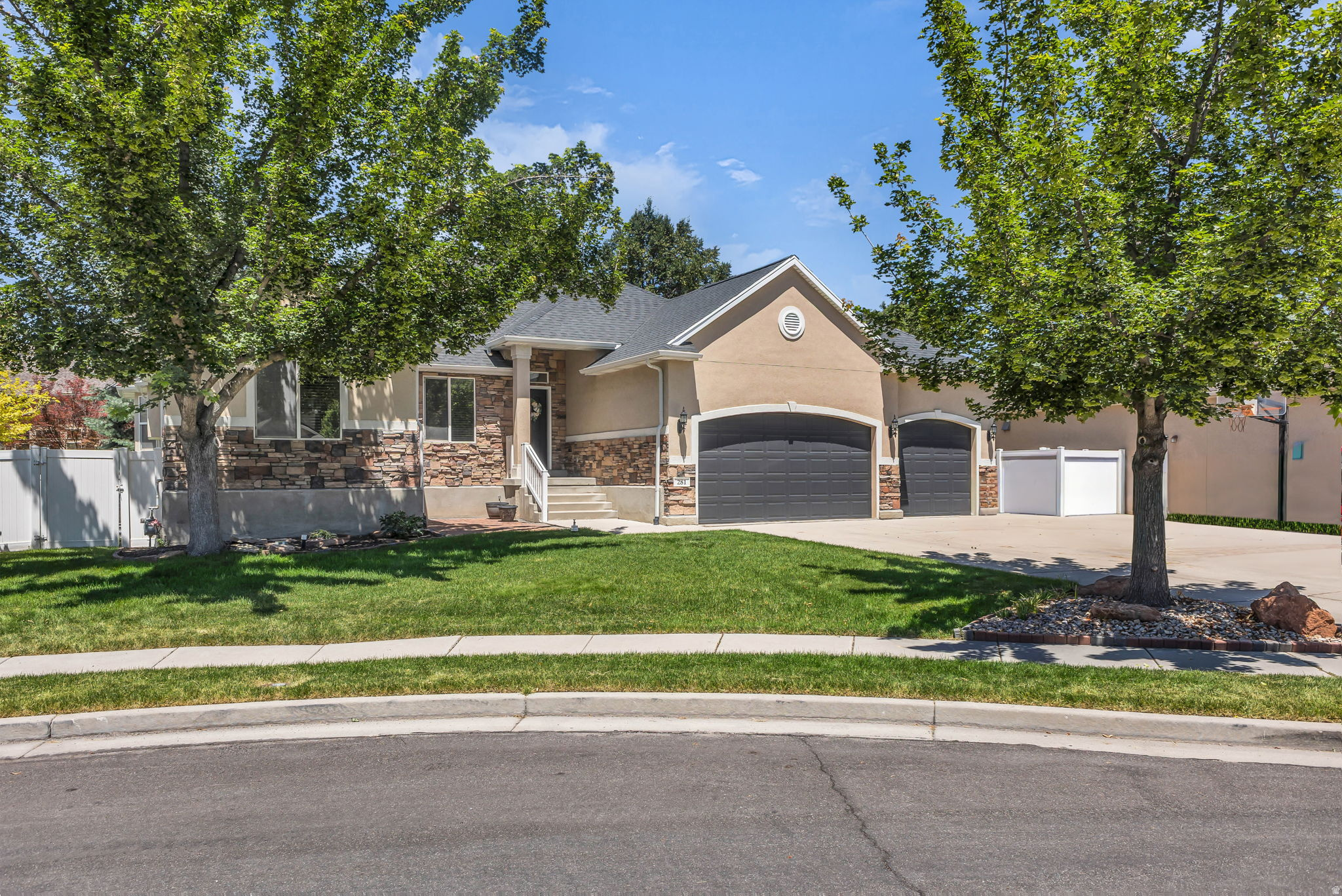 This home features a wonderful lot with lush landscaping that creates an inviting exterior. The interior offers an open, modern layout. The  kitchen boasts modern appliances and ample countertop space, providing an ideal setting for culinary endeavors.  The home's layout allows for a seamless flow between the indoor and outdoor living spaces. The deck and covered patio provide opportunities to enjoy the outdoors with feeling of a secluded yard.  The neutral tones and fireplace feature contribute to a warm and welcoming ambiance. Thoughtfully designed for comfortable living, this spacious home offers abundant storage, a basement kitchen, and three fireplaces. Recent improvements provide added peace of mind and include a radon mitigation system, updated HVAC, and a new roof installed in 2025.