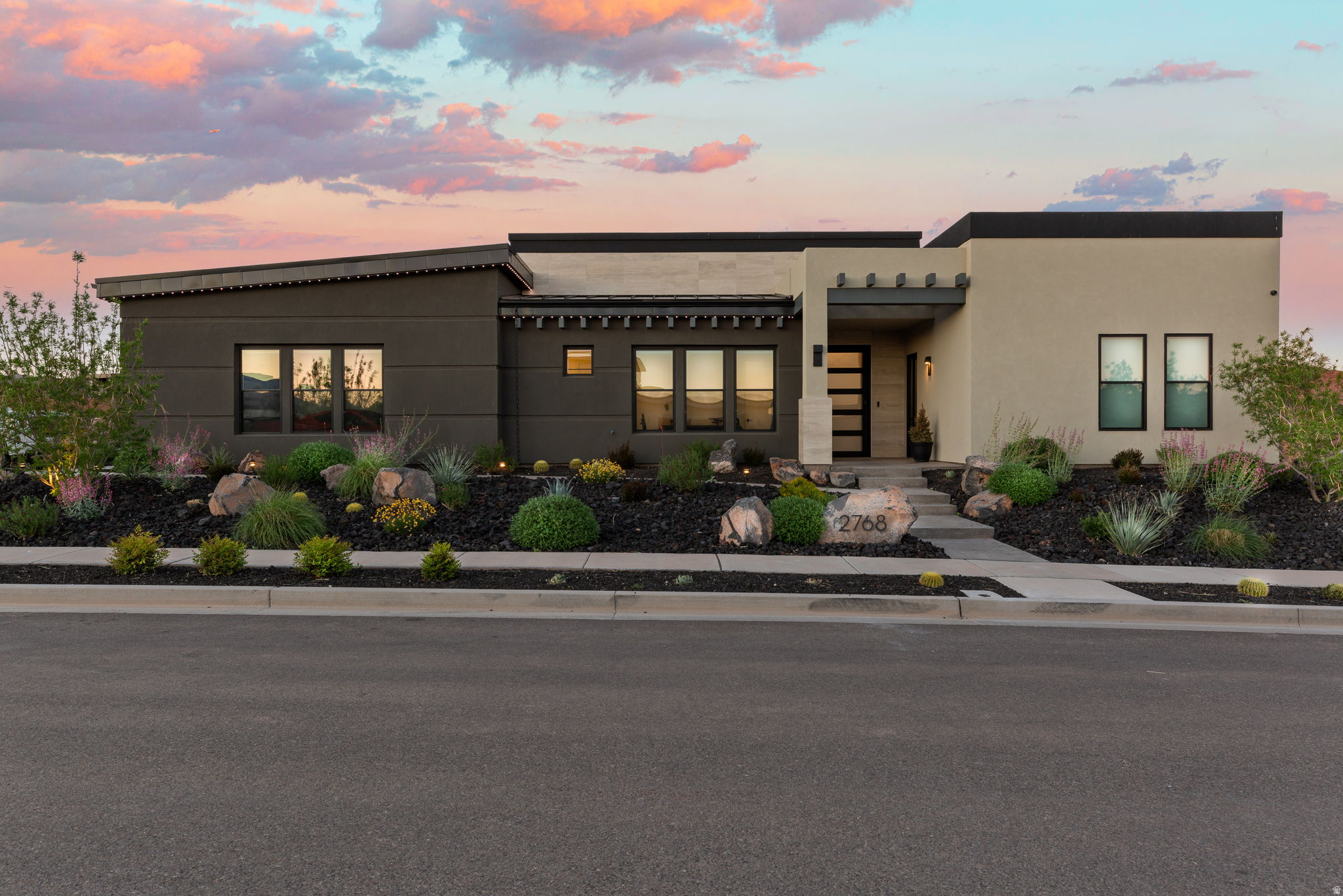 Experience elevated desert living in this stunning modern flat-roof home, perfectly positioned to capture breathtaking red rock views. Clean architectural lines and a thoughtfully designed layout create a seamless blend of luxury and comfort. The main living area is anchored by a striking fireplace with a custom accent wall, adding warmth and visual impact to the open-concept space. Large windows invite in natural light while framing the surrounding landscape. The kitchen and outdoor living spaces are designed for both everyday living and entertaining. Step outside to the true centerpiece of the home--a spectacular patio featuring panoramic views, a fire pit, and a built-in Wolf BBQ, creating an ideal setting for relaxing or hosting under the desert sky. The primary suite offers a spa-like retreat with a separate soaking tub and a spacious walk-in shower complete with a built-in bench. A private casita provides flexible living options, perfect for guests, extended family, or a home office. With its modern design, high-end finishes, and unmatched views, this home delivers an exceptional Southern Utah lifestyle. **Ask about the available furniture package as well