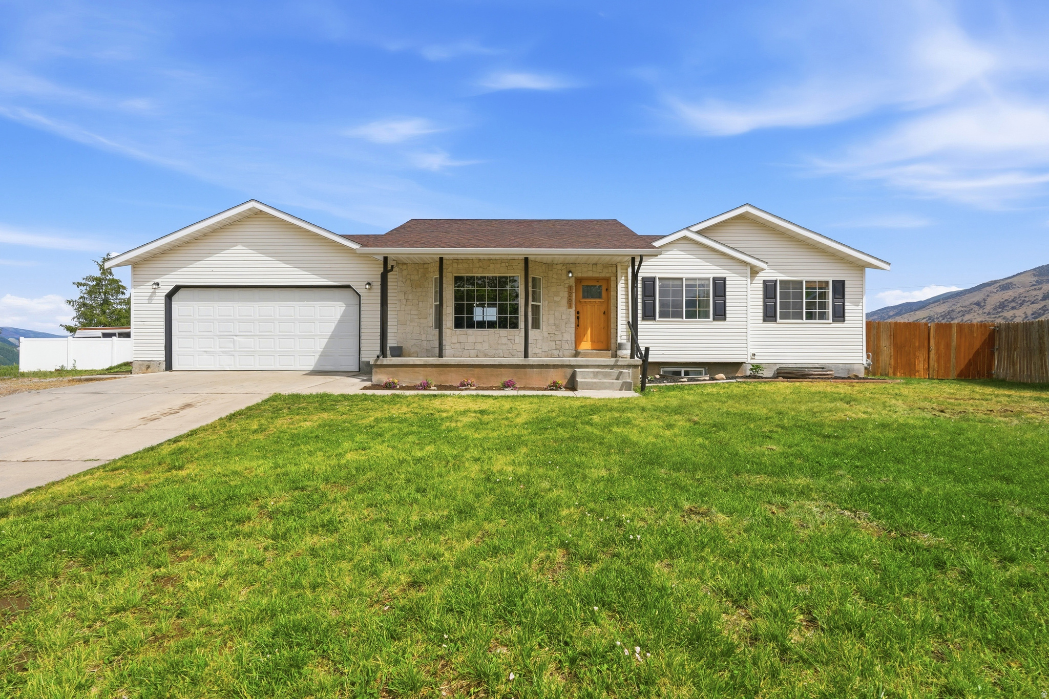 Welcome to this well-cared-for Hyrum home featuring thoughtful updates, functional living space, and a backyard built to enjoy. The bright main level offers an updated kitchen and bathroom, new LVP flooring, central AC, and an inviting layout with a comfortable primary suite. Downstairs, the fully finished basement adds incredible flexibility with 3 bedrooms, a den, cold storage plus it's plumbed for a 3rd bathroom. Outside, you'll love the fully fenced yard with playset, large insulated shed/workshop with power, heated garage (with separate breaker and 220v plug) and pressurized irrigation in both the front and back yards. Major updates including the roof (2017), water heater (2026), and kitchen (2026) provide added value and peace of mind. Tucked into a quiet neighborhood with beautiful mountain views, this home offers the perfect blend of comfort, updates, and everyday functionality.    Square footage figures are provided as a courtesy estimate only and were obtained from county records .  Buyer is advised to obtain an independent measurement.