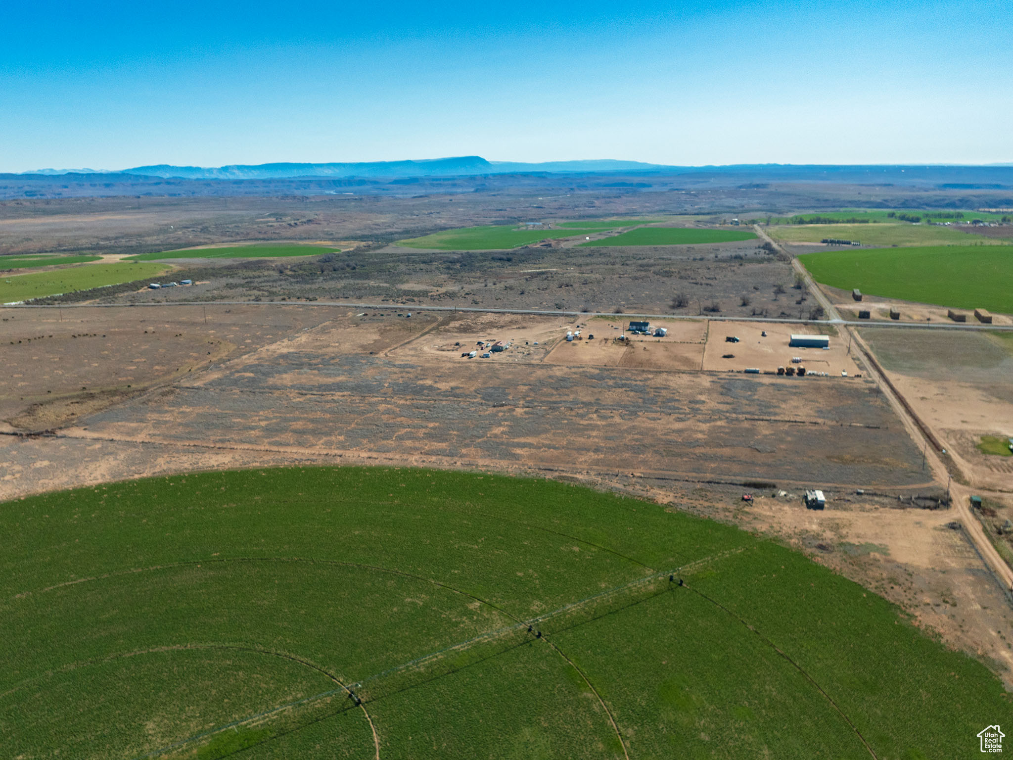 20 acre agricultural ground with water and wheel lines. Farm equipment can be included with a full price offer. Abundant space to cultivate, develop, or construct, tailored to your vision, with year round access. Included are 70 Ouray Park Class G Water Shares, ensuring robust irrigation potential, parcel is on Greenbelt status for tax advantages. Buyer will be responsible for rollback taxes if not used for greenbelt. The property is equipped with a two wheel line irrigation system, with direct 5000 South road access. Power is connected, featuring 3-phase power on the south-west corner power pole on the property. Partially fenced for convenience. Industrial zoned. Perfectly positioned in a rapidly growing area-ideal for businesses seeking to expand or relocate. This prime location is poised for growth and productivity. Buyer to verify all details.