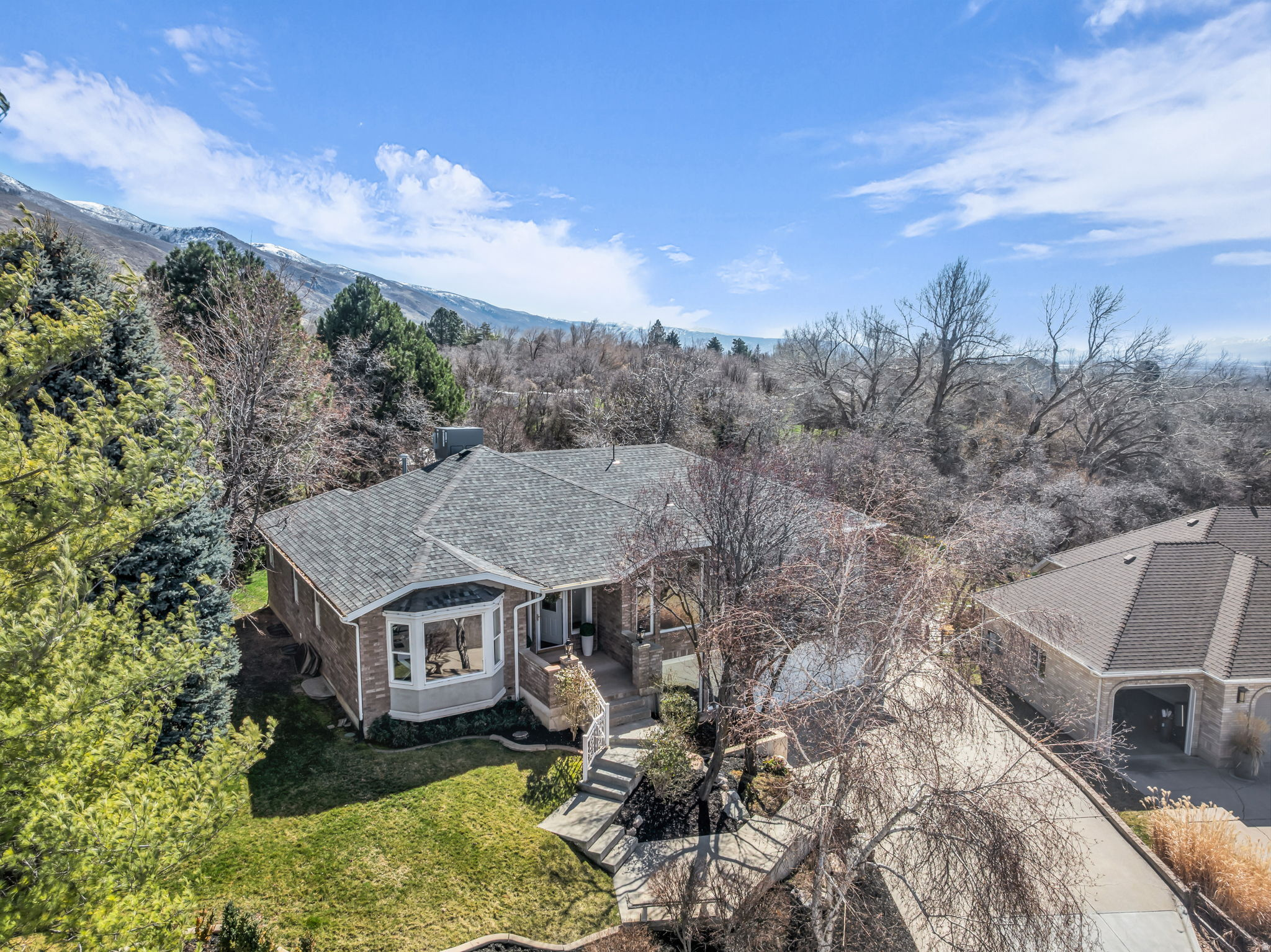 This Stunning High End Remodeled home sit on a Lush .65 Acre lot in Custom Home Neighborhood.  Year Round Spring feed Stream flows through Property.  Incredible Mountain Views from Private Gazebo or the Large 2 Level Patio.  Custom Flooring Throughout, Fresh Paint. Immaculately cared for.  Chefs Kitchen with Top of the line Appliances, Custom Ceiling Height Cabinets, Large Center Island, Open to the Grand Family Room with Wall of Windows to take in the Views.  Formal Dining Room and Living Rooms off Foyer. Serene Primary Owners Bedroom  with Attached En Suite Bathroom and Walk in Closet.  2 Additional Main Level bedroom and Main level Laundry. Fully Finished Walkout Basement with 2nd Family Room/Rec Room with French Doors leading out to the Backyard.  2 Lower level Bedrooms and Updated Bathroom. Oversized 2 Car Garage with Side Parking.   Square footage figures are provided as a courtesy estimate only.  Buyer is advised to obtain an independent measurement.