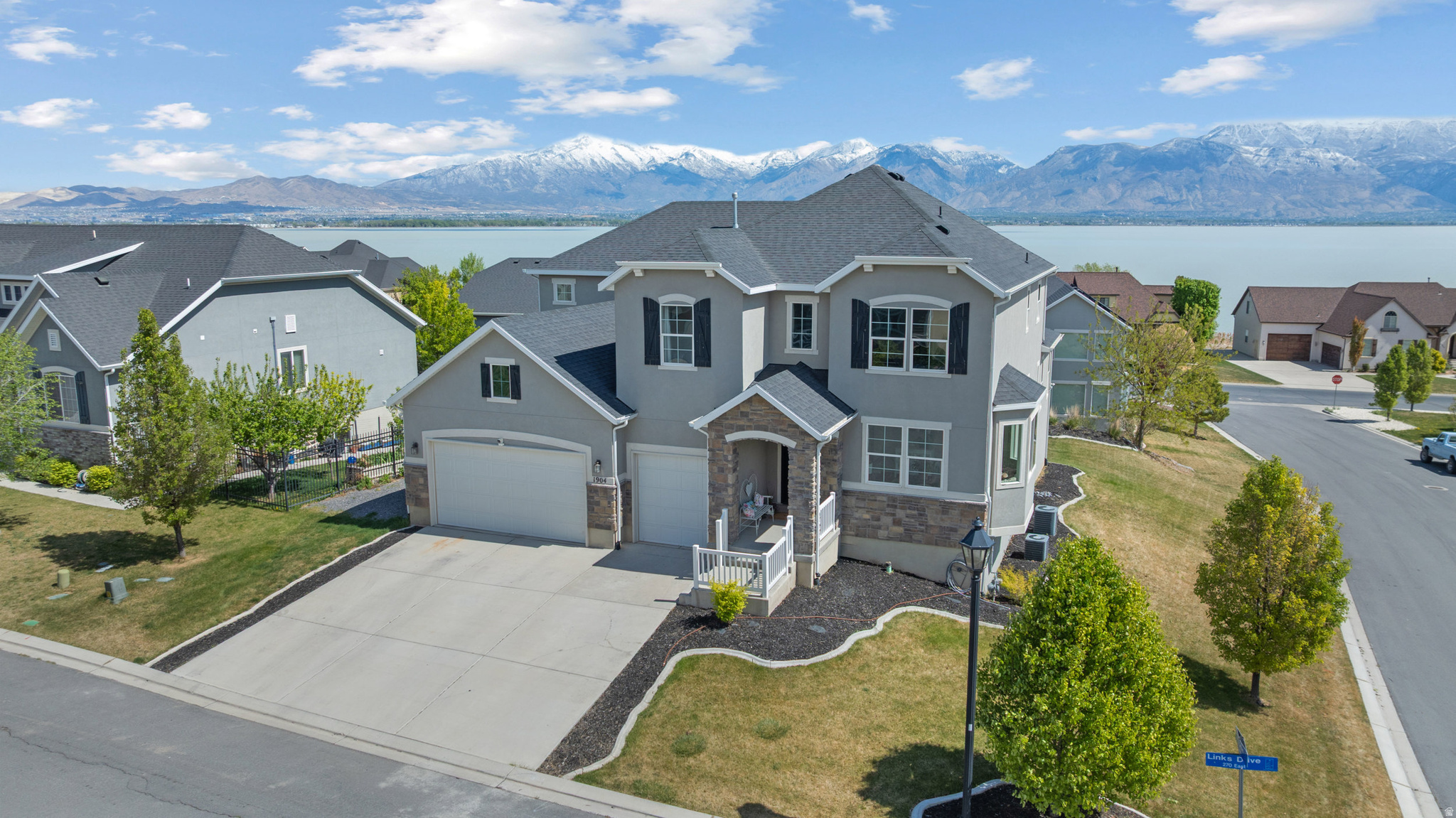Homes in the Ironwood at Saratoga community rarely stay available. The SSOA gated amenity package, private marina, year-round heated pools, two clubhouses, two gyms, golf, and miles of maintained trails make this one of the most complete lifestyle communities in Saratoga Springs. Situated on a .25 acre corner lot with unobstructed lake, mountain, and valley views, this 5,396 square foot home offers 4 bedrooms, a dedicated office, 3.5 bathrooms, and a private theater room - room to live, work, and entertain without compromise. The main floor is anchored by a 10-foot kitchen island surrounded by 42-inch white shaker cabinetry, granite countertops, and double wall ovens. Vaulted ceilings, a primary suite positioned for privacy with a separate soaking tub and walk-in closet, a dedicated en-suite bedroom, and new carpet throughout. What truly sets this home apart is what comes next. The basement already includes a theater room wired for Atmos 9.4 surround sound, a golf simulator space, and a wet bar/kitchenette completely roughed in. The infrastructure is done; the design is yours. Whether you finish it as a gym, additional bedrooms, game room, or flex living space, you are customizing, not completing someone else's vision. Outside, permanent exterior lighting, a custom iron front door with smart glass, and a fully landscaped corner lot with lake and valley views that are becoming harder to find at any price point. For buyers looking for space, views, a gated lifestyle community, and genuine future upside, without crossing into the million-dollar range, this home deserves a closer look. Sauna and outdoor kitchen negotiable. Square footage figures are provided as a courtesy estimate only and were obtained from Utah County.  Buyer is advised to obtain an independent measurement.