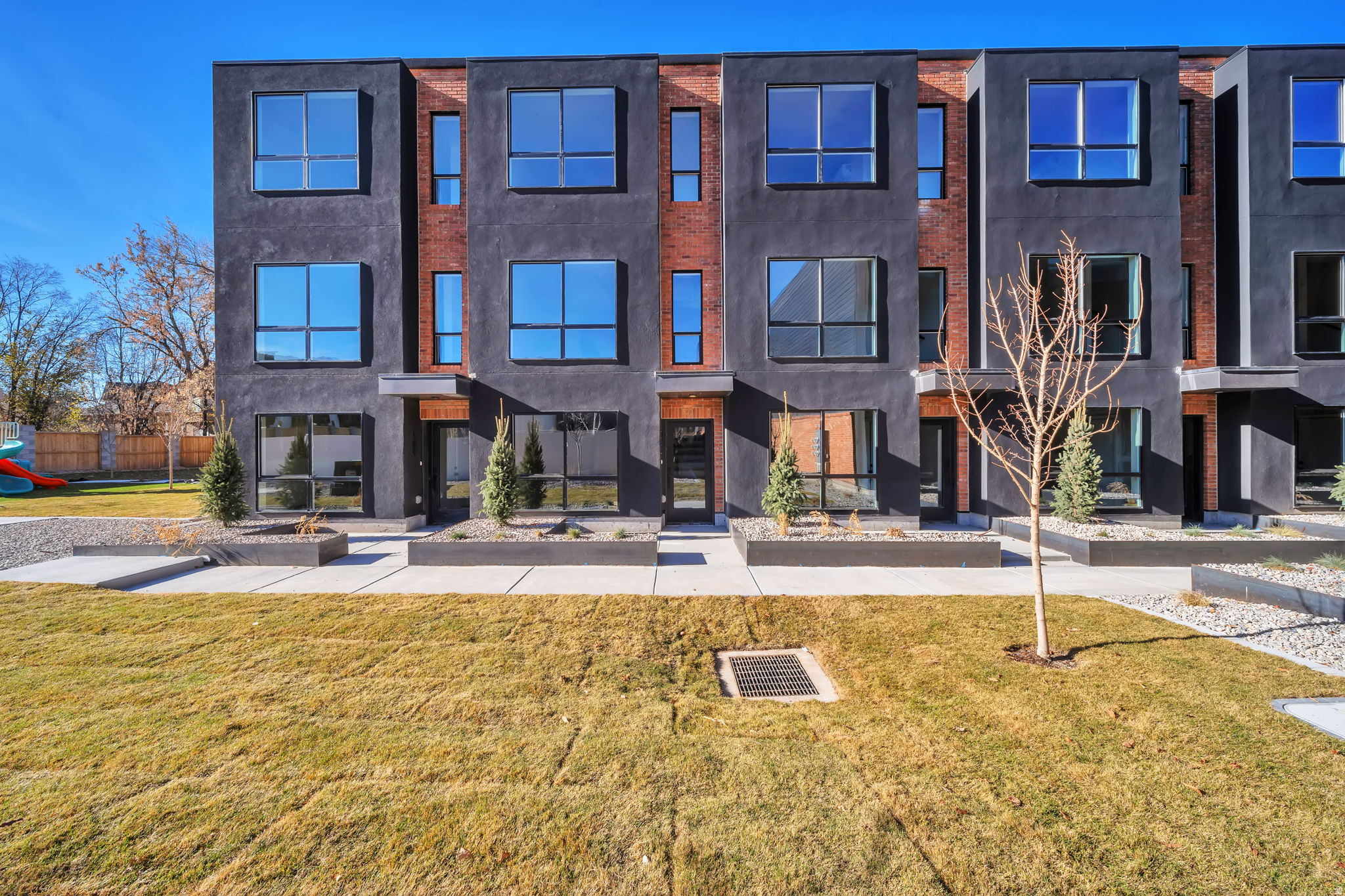 Incredible opportunity to own 14 brand new rental townhomes in the heart of Millcreek. There are thirty-one total units in this complex each with their own tax id. So its possible to buy two full building of 14 units or break it up into different unit counts. Each high-end townhomes has premium interior finishes including quartz waterfall countertops, modern cabinetry, high efficiency HVAC, Google Fiber, ample windows providing an abundance of natural daylight and its own tandem 2 car garage. Common area pickleball/sport court and park. Wonderful east side Millcreek location close to ski resorts, downtown Salt Lake, great schools and shopping. Call to schedule an accompanied walk through.