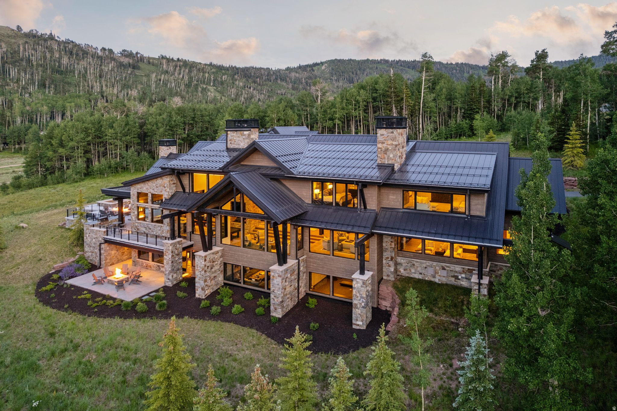 Positioned on nearly 12 private acres within the coveted Phase 5 enclave of The Colony at White Pine Canyon, 302 White Pine Canyon Road represents one of Park City's premier ski estates. Encompassing approximately 16,716 square feet with direct ski-in/ski-out access, the residence is surrounded by an extraordinary collection of private amenities, including scenic lakes, cascading waterfalls, exclusive ski runs, groomed cross-country trails, hiking paths, and expansive protected open space, creating an unmatched year-round mountain lifestyle. The main level is designed for effortless living and entertaining, featuring a spectacular great room with soaring ceilings and a dramatic two-sided stone fireplace, a chef's kitchen with premium Wolf, Sub-Zero, Miele, and Cove appliances, dual islands, a spacious hearth room, formal dining, an impressive entertaining bar, private office, and a luxurious primary suite with fireplace, spa-inspired bath, steam shower, soaking tub, and oversized custom closet. Four guest bedroom suites, two custom bunk rooms, and a dedicated children's study provide exceptional accommodations for family and guests. The lower level is designed for recreation with a spacious media and game room, TrackMan golf simulator, fitness center, and an outstanding ski room featuring custom lockers, boot dryers, gear storage, dedicated ski laundry, and direct access to the heated ski patio. Outdoor living is equally impressive with heated patios, covered gathering spaces, fire features, outdoor kitchen, Diamond Spa, and multiple seating areas perfectly positioned to enjoy the peaceful meadow and mountain setting. A private tow rope provides effortless ski access while creating the perfect family sledding hill. Additional features include Control4 smart home automation, Lutron lighting, integrated Sonos audio, elevator, oversized heated three-car garage with bonus trail-access bay, extensive storage, heated motor court, and abundant outdoor living spaces. Offering direct ski access, remarkable privacy, and one of the finest view corridors in The Colony, this is a rare opportunity to own one of Park City's truly exceptional legacy estates.