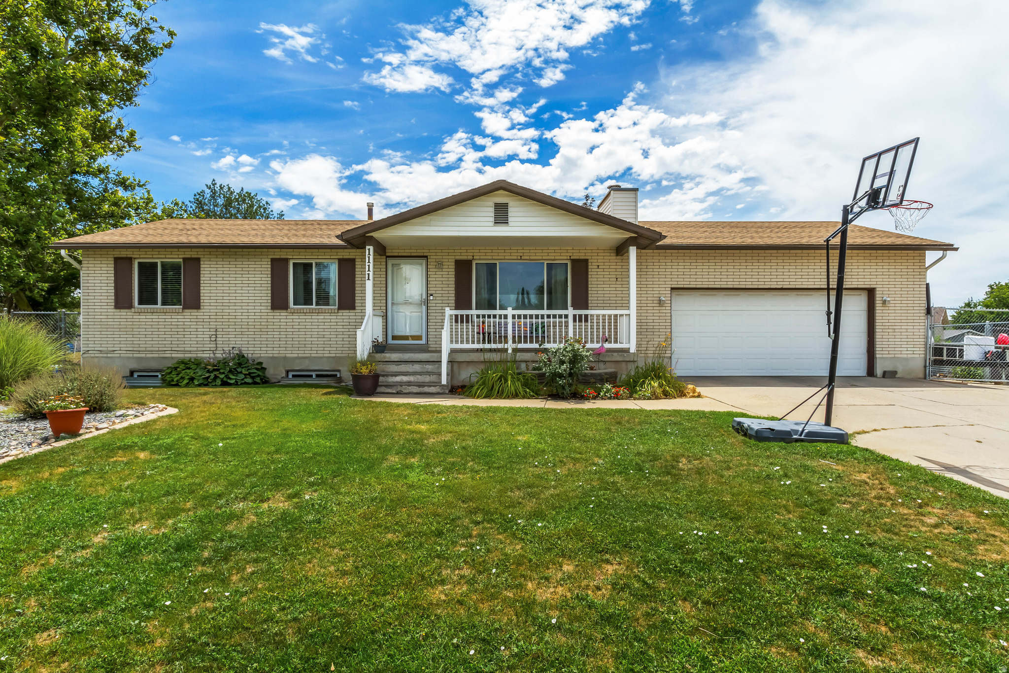 Set beneath the mountains in Layton, this spacious 5-bedroom, 2-bathroom home offers 2,348 square feet across two thoughtfully finished levels. The main floor spans 1,161 square feet and features an updated kitchen with quartz countertops and new flooring, creating a fresh, move-in-ready feel. Downstairs, the 1,187-square-foot basement offers additional living space along with a 3/4 bathroom, plus salon equipment that is negotiable with the sale - a rare bonus for anyone looking to run a business from home (fully functional salon). This room can easily be converted back to a bedroom, bringing the total bedroom count to 6 .All appliances are included, even the washer and dryer, making this a truly move-in-ready opportunity. Outside, the 0.29-acre lot is built for storage and hobbies alike, with a 2-car garage, extra-deep RV parking, and two storage sheds, one of which is wired with power. A swing set is also included. Enjoy mountain views right from the property, all with no HOA to worry about. Conveniently located in Layton with easy access to area parks, trails, shopping, and dining, plus a quick connection to I-15 for commuting throughout Davis County. Priced at $504,999, this home combines everyday functionality with room to grow. Schedule a showing today.