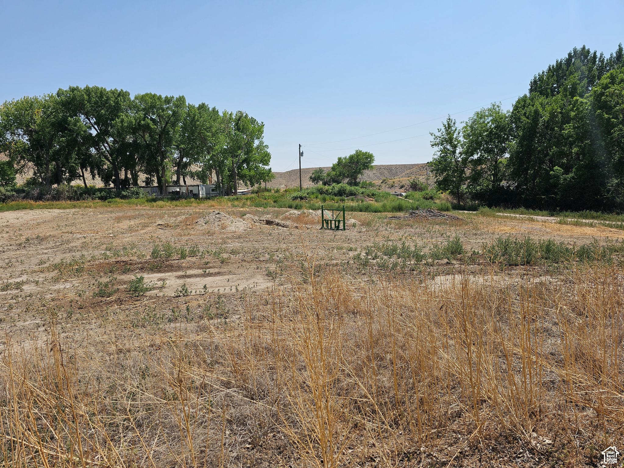 BRIDGELAND!!  A beautiful building site in a high demand, low supply area!  Flat and buildable! Culinary water, power, and septic system available at buyer's expense.  East of Duchesne in Farm Country!  Great neighbors!  Easy year 'round access!  Paved frontage on a county maintained road. School bus route.  From highway 40, turn south on 9250 West.  In approximately 1 mile, the road curves to the west.  The property is on the south side of the curve.
