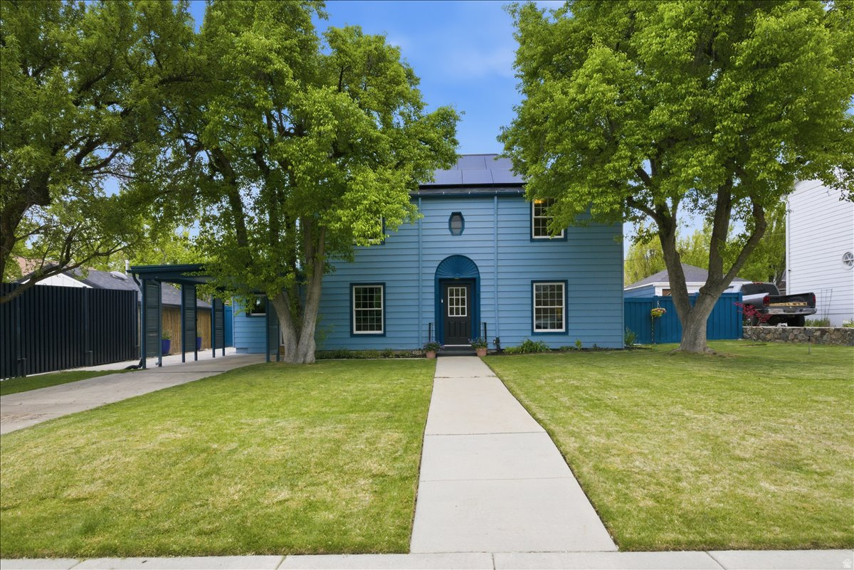 Situated on an expansive .23-acre lot in the East Bench, this classic 1940s home offers a prime location and significant scale. Whether you're interested in restoring a vintage gem or capitalizing on the large footprint in a sought-after neighborhood, the opportunity here is unmatched.  The traditional layout and character are intact with original wood floors and the upper level hosting a hard-to-find three bedrooms and two bathrooms. A primary suite on the main level consists of a spacious bedroom, an en suite, and access to the patio.  Impressive sustainability-focused updates have completely eliminated natural gas: a solar array (paid-off in full), mini split heating and cooling system, and an EV charging station. The roof was replaced in 2018 and upgrades have been made to the plumbing, including an electric water heater.  Positioned on a vibrant street with quick connections to the heart of the city, just minutes from the University of Utah and downtown. Walking distance from parks, excellent schools, a public library, Harmon's Emigration Market, and locally-owned restaurants.