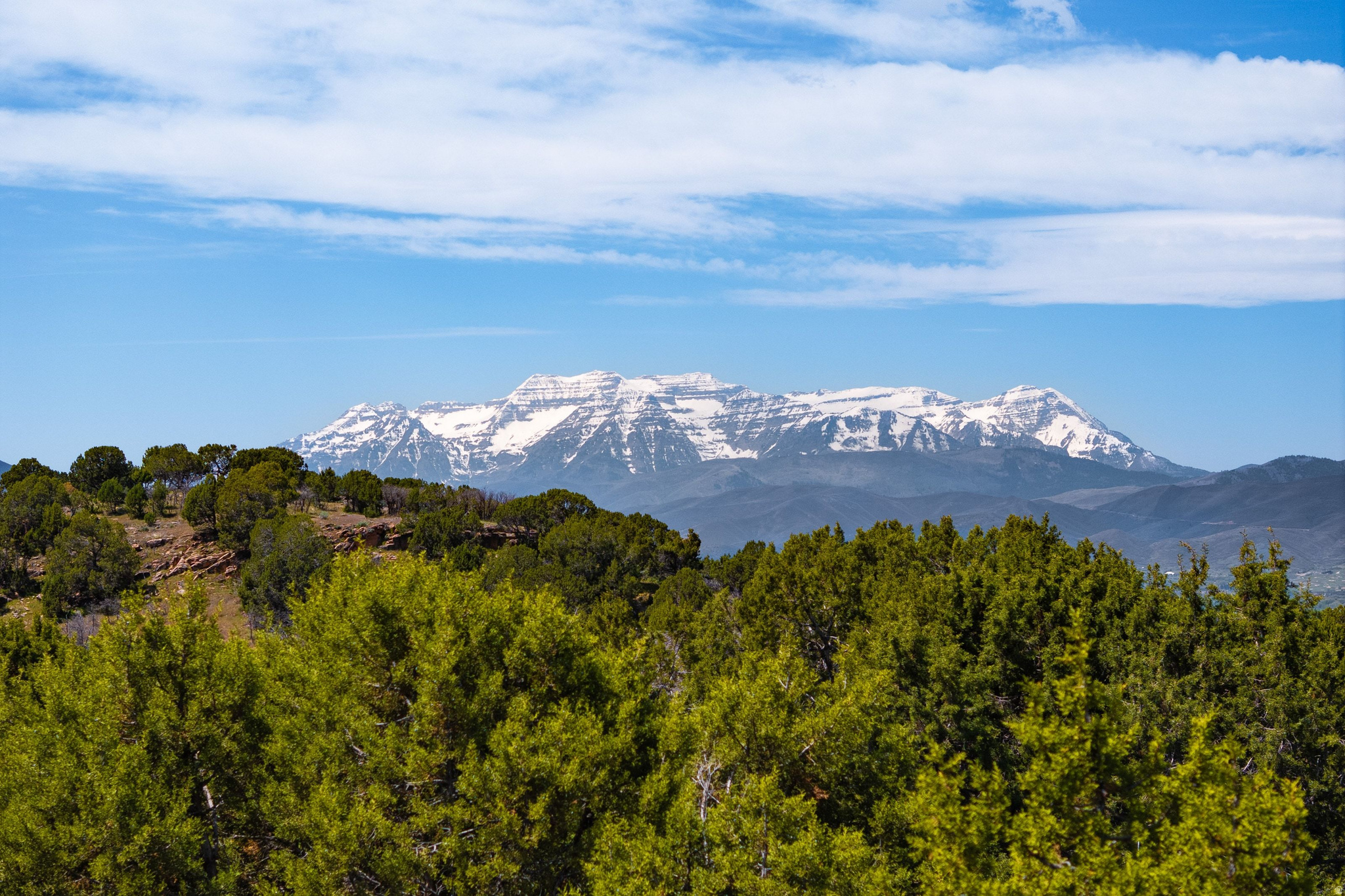 Found within the breathtaking landscape of Red Ledges, this exceptional homesite offers the opportunity to create a refined mountain retreat within one of Utah's premier private golf communities. Spanning over three-quarters of an acre, the gently sloping downhill build site is surrounded by mature native juniper trees and captures sweeping southern and southwestern views, including Mount Timpanogos, all enhanced by neighboring protected open space that provides exceptional privacy and tranquility.  Thoughtfully positioned to maximize both scenery and livability, the property offers convenient access to Red Ledges' extensive collection of world-class amenities. Owners enjoy resort-style pools, state-of-the-art fitness facilities, tennis and pickleball courts, dining venues, and an expansive trail system ideal for hiking, biking, and horseback riding. The community's equestrian center and seasonal Deer Valley shuttle service further elevate the mountain lifestyle experience.  Additionally, with access to a Red Ledges Golf Membership owners gain access to the award-winning Jack Nicklaus Signature Golf Course, Golf Park, practice facilities, and the club's full suite of luxury amenities and experiences.