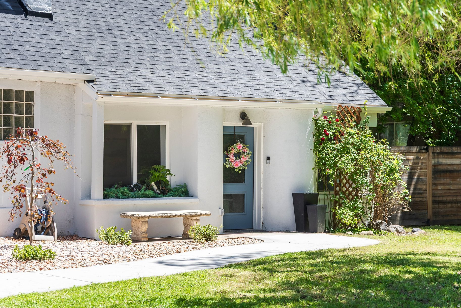 A dream cottage in the city, this charming Millcreek home sits on a rare 1/3-acre lot that has been deeply loved and thoughtfully cared for. Its location is truly unmatched - offering the perfect balance of peaceful living and everyday convenience, all within walking distance to the new Millcreek Commons and is in the slower School Zone section of 1300 East.  This turnkey home blends warmth, character, and modern upgrades throughout. Inside, you'll find quartz countertops, a waterfall island, stainless steel appliances, custom finishes, and a built-in Sonos sound system throughout the home, creating the perfect atmosphere for entertaining. For years, this home has been the gathering place for friends and family making it a space filled with warmth, memories, and connection. The private primary suite features its own entrance and patio access, offering a serene retreat all its own or the perfect rental opportunity. One of the most loved aspects about this home's location is the incredible sense of community and the wonderful neighbors who make this area feel so special from surrounding residences to business owners. Outside, the property feels like a hidden oasis with mountain views, mature landscaping, a tranquil stream with a rare 1 water share included, and a prolific apricot tree enjoyed season after season. The expansive lot also offers incredible potential with plenty of room for an ADU, future expansion, or additional outdoor entertaining space. With nearly every detail thoughtfully updated, this special property is ideally located just minutes from the University of Utah, Westminster University, Millcreek Canyon hiking and biking trails, world-class ski resorts, shopping, dining, and St. Mark's Hospital. A rare opportunity to own a home with charm, land, lifestyle, and future potential in one of Salt Lake's most desirable neighborhoods.