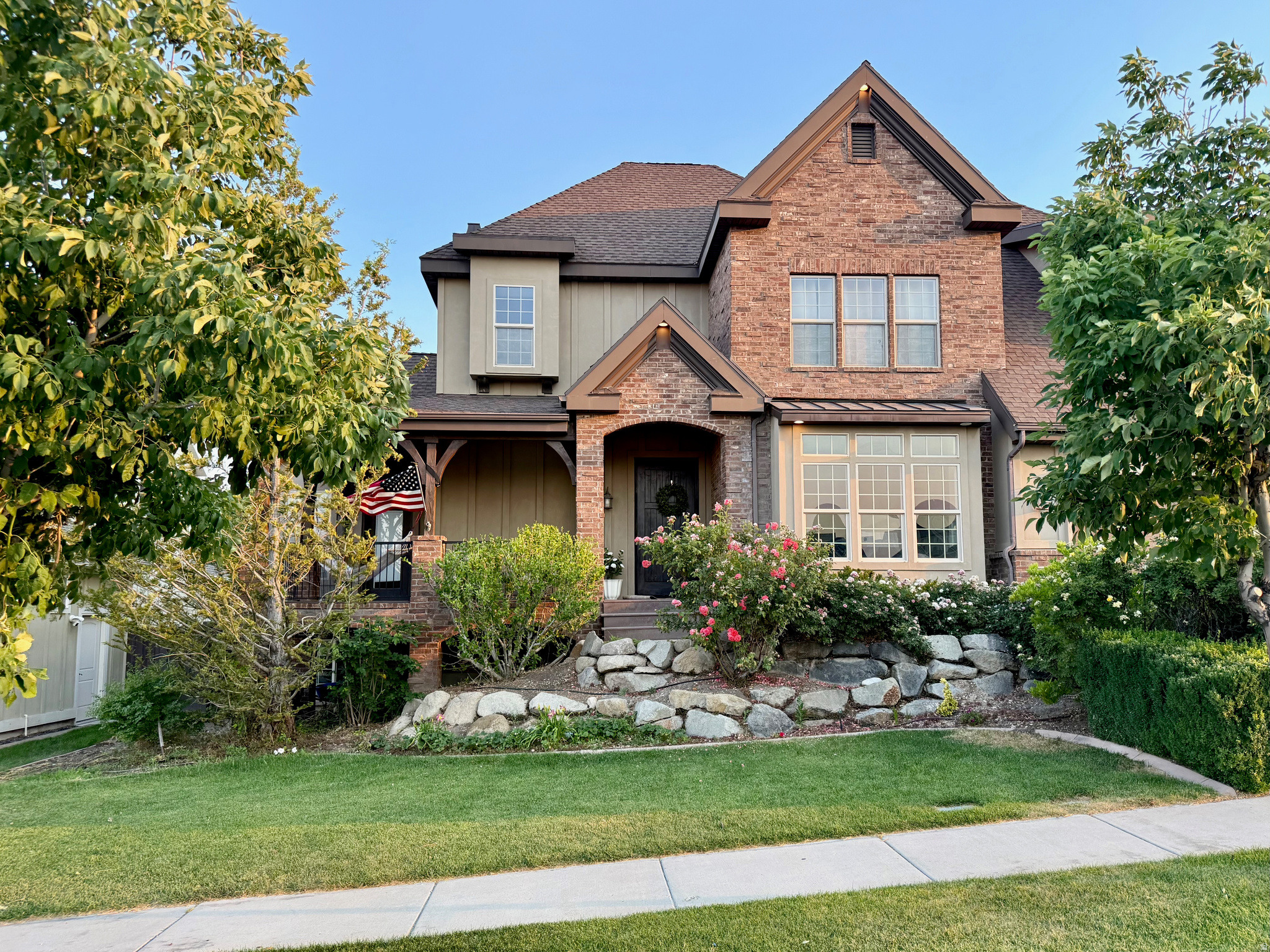 This beautiful and original custom home is located in the Eagle Summit neighborhood of Traverse Mountain. With no neighbors across the street, the home showcases quiet mornings on the covered front porch and expansive views of the lake and valley. The timeless design offers custom millwork, large light filled windows, two double sided fireplaces and the use of natural materials - such as wood and marble floors, and soapstone countertops. The thoughtful floor plan grows well through all of life stages with a primary suite and laundry room on the main floor, 4 bedrooms and 2 bathrooms on the second floor, and two additional bedrooms, two bathrooms and laundry in the basement. Some favorite features of the home are the 48" range with double ovens, spacious primary bathroom with freestanding tub and large walk-in shower, sun filled office/ homework room, high ceilings through out, home gym with lots of windows, and the daylight walk out basement. The backyard includes ample flat grass space, a large deck, stone patio, peach tree, grapes, raspberry patch and garden boxes. The Traverse Mountain community has schools, shopping, parks, pickleball and tennis courts, community pool and clubhouse within walking distance. The location, view, and amenities make this a fantastic place to call home!