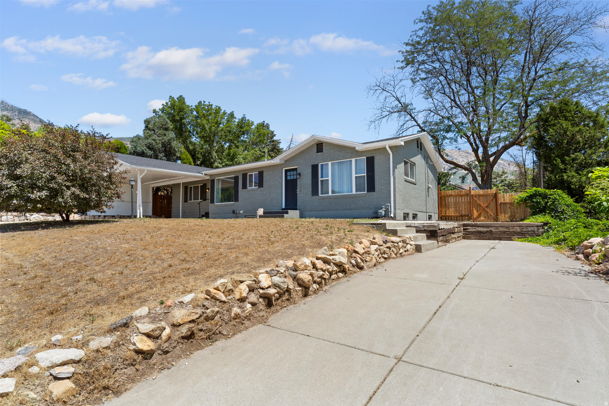 Welcome to this beautifully updated 4-bedroom, 2-bathroom home located in the highly desirable area of North Ogden, Utah. This spacious residence offers the perfect combination of modern upgrades, functional living space, and a peaceful setting with stunning surroundings.  Step inside to discover a thoughtfully renovated interior featuring granite countertops, stainless steel appliances, and durable solid surface flooring that adds both style and practicality. The open and inviting layout provides a comfortable flow between the living, dining, and kitchen areas-perfect for both everyday living and entertaining.  Stay comfortable year-round with central air conditioning, while large windows allow for plenty of natural light throughout the home. The fully finished basement adds valuable additional living space, ideal for a second family room, home office, gym, or extra storage.  Outside, you'll find a covered patio-perfect for relaxing evenings or outdoor dining-as well as multiple storage sheds to keep your belongings organized. Covered parking helps protect your vehicle from the elements, adding another layer of convenience.  Located in a quiet and scenic North Ogden neighborhood, this home offers easy access to local parks, schools, shopping, and outdoor recreation, all while providing a peaceful residential feel.  Don't miss the opportunity to make this well-appointed home yours!