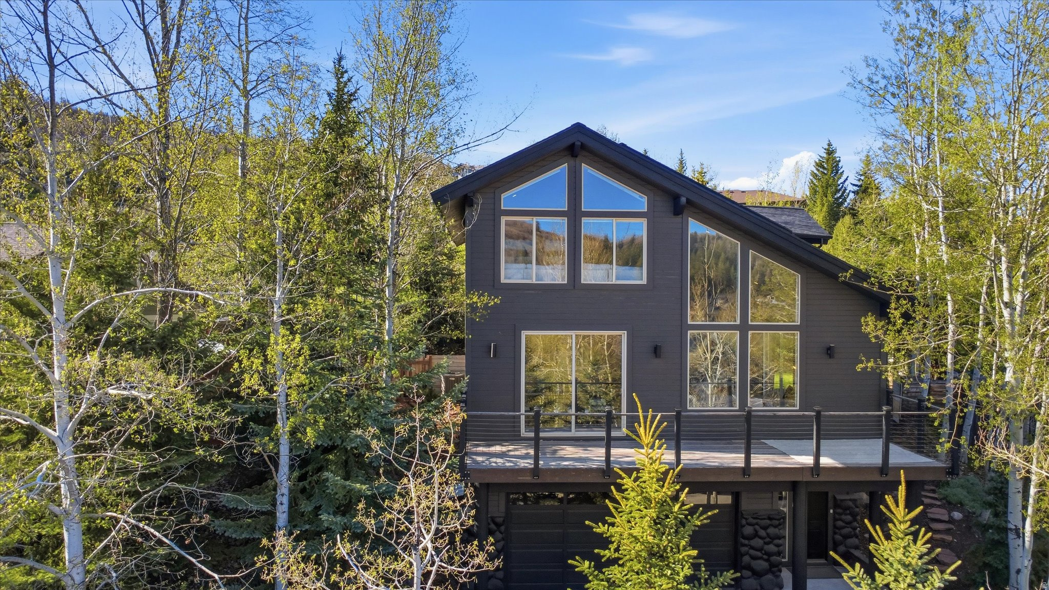 Tucked into a quiet cul-de-sac on Sunrise Drive, this nearly 3,000 square foot, 3 bedroom, 2 bath home offers an airy, open feel, capturing everything that makes Park City living special. True to its name, Sunrise Drive delivers daily moments worth slowing down for, as golden light rises over the Wasatch and fills the home with warmth and incredible mountain views. Located in the sought-after South Ridge neighborhood of Jeremy Ranch, this home offers a rare balance of privacy and convenience, with direct access to scenic hiking and biking trails, a neighborhood dog park and community tennis courts. World-class skiing and historic Main Street are just 15 minutes away, and Salt Lake City International Airport is under 30 minutes, making it easy to get in, get out and get back on the mountain. Inside, vaulted ceilings and dramatic two-story windows flood the main living space with natural light and create a seamless connection to the surrounding landscape. The open kitchen, complete with upgraded appliances and granite countertops, flows easily into the living area and out to two separate decks, giving you multiple options for dining, entertaining or simply taking in the view. Upstairs, the expansive primary suite feels like a retreat of its own, featuring vaulted ceilings, a spacious walk-in closet, a private deck and a spa-style bath with jetted tub. A versatile loft adds a second living space, perfect for relaxing, working from home or hosting guests. Step outside to a spacious backyard surrounded by mature trees, offering plenty of room to relax, play or create your ideal outdoor setup, along with a patio space designed for easy entertaining and everyday living. Recent upgrades including a new roof, furnace, A/C and water heater bring peace of mind, while the extra-deep garage offers plenty of room for storage, gear or weekend toys. Offered fully furnished at no additional cost, this home is ready to enjoy from day one. Whether you are looking for a primary residence or a turnkey mountain escape, this property delivers an effortless Park City lifestyle.