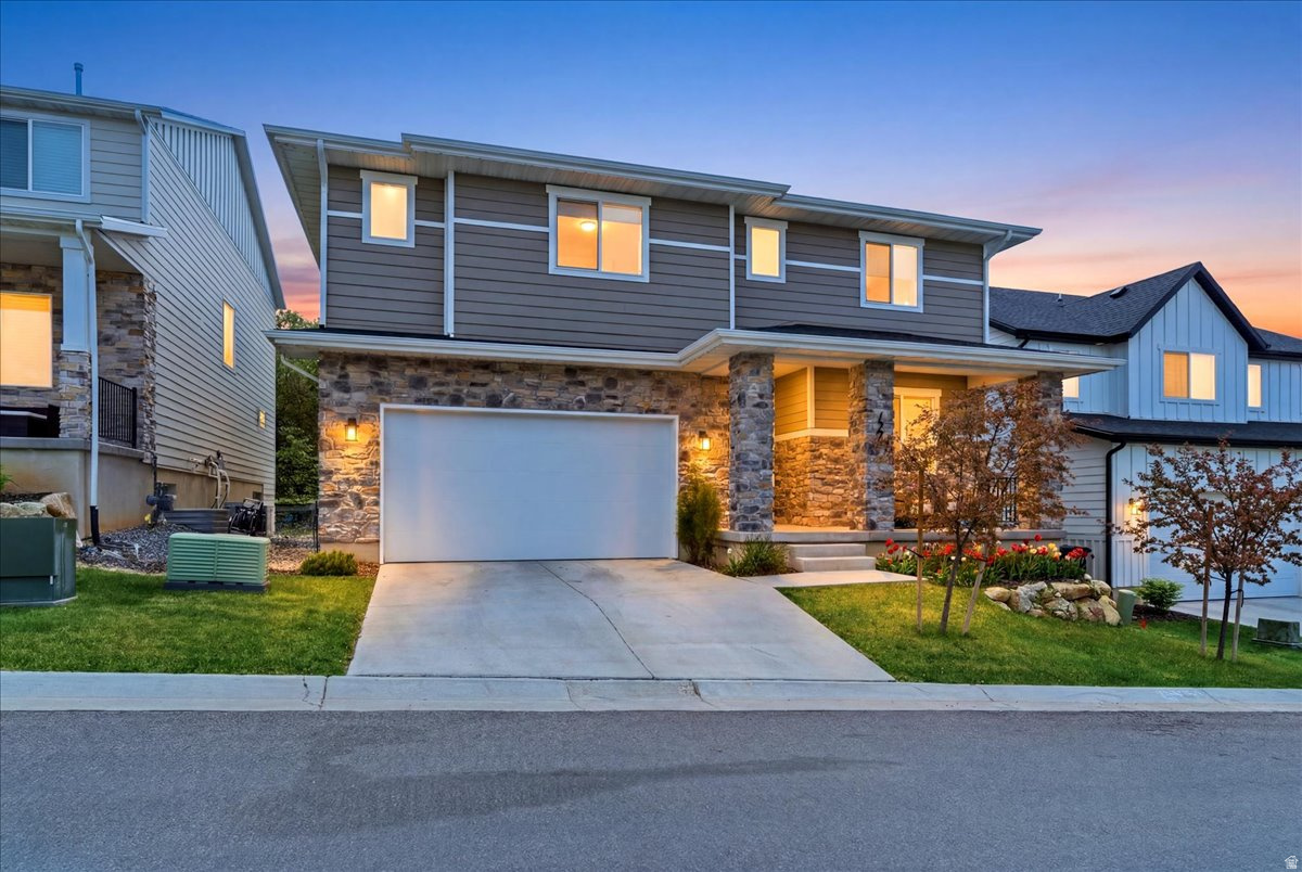 Kaysville luxury 4,145 sq ft home with walkout basement, 3-car tandem garage, 6 bed, 4 bath with mother-in-law apartment in sought-after Talbot Estates! Mountain and valley views, full landscaping, and upscale finishes throughout. Open-concept layout with gas fireplace and gourmet kitchen featuring craftsman-style cabinets, quartz countertops, and stainless appliances, including gas cooktop and wall oven. Spacious owner's suite with double walk-in custom closets by closets butler, double vanity, daylight solar bathroom fan and large shower. Fully finished walkout basement with second kitchen and laundry hookups. Central air, hardwood/tile/carpet flooring,  water softener, smart home features, covered porch, permanent exterior LED  lighting and large deck. Conveniently located near parks and Hwy 89 for an easy commute. Buyer to verify all information. Call for an appointment today! Easy to show!