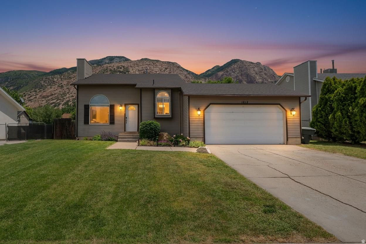 Welcome home! Mountain views. Massive covered deck. And an incredible price. This west-facing 3 bedroom, 2 bathroom home offers the perfect combination of comfort, outdoor living, and value. Tucked by the mountains & close to parks, trails, and shopping, it's ideal for anyone wanting both convenience and a little breathing room. Inside, you'll find a functional layout with great natural light, vaulted ceilings on the main level, cozy fireplace, and updates throughout while the 2-car garage adds everyday convenience. The new roof (2023) provides peace of mind. Step outside to the huge covered deck (20x20), creating an extended living space that's perfect for entertaining, relaxing, or enjoying summer nights with a view. Fully fenced east facing backyard is perfect for evening shade as you watch the mountains glow during sunset. Whether hosting friends or unwinding after a long day, this is where the home truly shines.  If you've been looking for a home that offers outdoor lifestyle, mountain views, and strong value in a quiet, well-located area... this is one you don't want to miss.