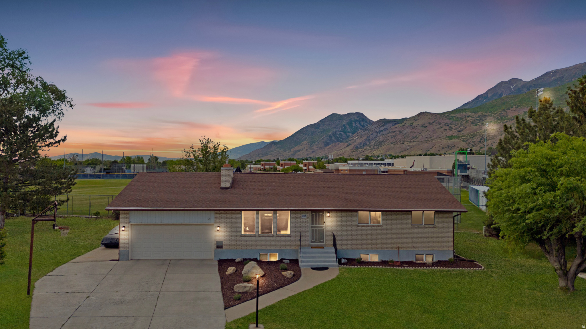 Prime Orem location just minutes from Utah Valley University. Perfect for families, college students,  or investors! Has a basement walkout with potential to add an ADU! Making it a great opportunity to add future value. This move-in-ready brick rambler features an open-concept kitchen with granite countertops and stainless steel appliances, main-level laundry, and two bedrooms on the main floor. The stunning basement family room with a stone-clad fireplace is a showstopper, with additional bedrooms and bathrooms offering incredible flexibility. Step outside to a private backyard, concrete patio, and breathtaking Wasatch Mountain views. Attached 2-car garage, updated baths, and easy access to I-15, shopping, and dining. Homes like this don't last , schedule your showing today!