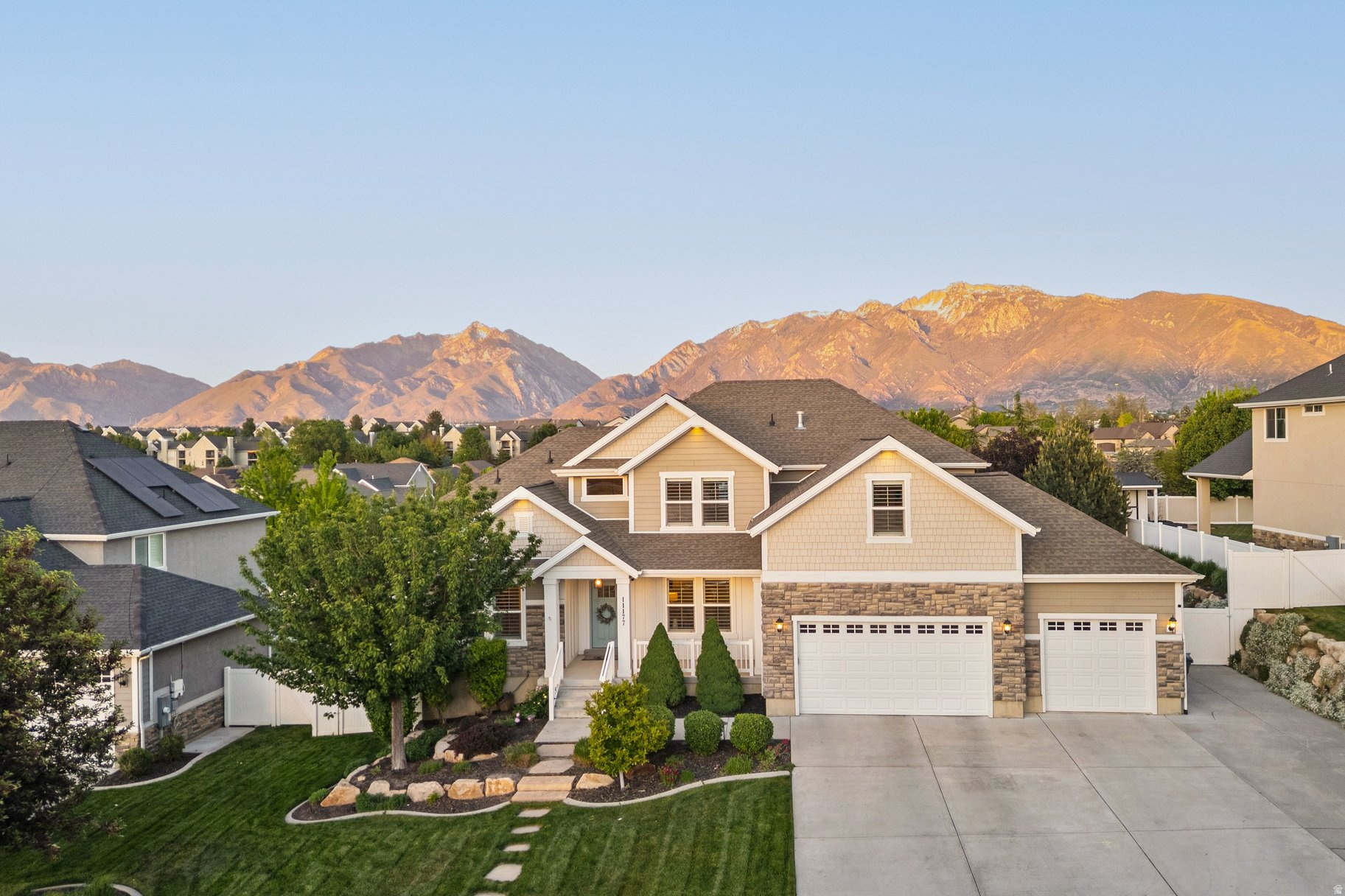 NEW IMPROVED PRICE - Appraised 5/18/2026 for $1,250,000. See attached docs INSTANT EQUITY. This is the kind of home that changes how you live. Built in 2014 and tucked into a quiet South Jordan neighborhood, with easy access to the freeway and surrounded by lifestyle amenities, this home effortlessly blends expansive indoor spaces with abundant outdoor living. Natural light pours through oversized windows. The backyard becomes another living room. Summer evenings belong on the covered deck beneath mountain sunsets and soft alpenglow along the Wasatch Front. Oak hardwood floors, soaring ceilings, open floor plan, vaulted ceilings, a media room, second kitchen, hot tub, outdoor fire pit, cascading waterfall feature, hammock, basketball court, mature landscaping, and breathtaking mountain views create a property that lives substantially larger than its footprint. The east-facing backyard is a hidden advantage - shaded, comfortable, and designed for long summer evenings outdoors. From morning sunrise to glowing mountain sunsets, every window reminds you why you live in Utah. Thoughtfully upgraded with epoxy garage flooring, exterior holiday trim lighting, professionally designed landscaping, and a detached storage shed large enough for serious storage or vehicle use, this home balances beauty, function, and everyday joy.