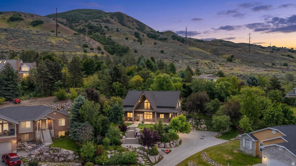 *NEW LISTING THAT IS SURE TO IMPRESS* Tucked at the base of the mountains on a quiet cul-de-sac, this one-of-a-kind 2-story home offers the perfect blend of quality craftsmanship, thoughtful updates, and breathtaking valley views. Unlike the typical cookie-cutter homes nearby, this property has character, warmth, and room to grow-all in one of the most desirable locations in the area with no backyard neighbors. The main-level primary suite creates convenient everyday living, complete with a recently updated bathroom designed to feel like a private retreat. Throughout the home, you'll appreciate the extensive upgrades already completed for you, including new hardwood-style LVP flooring, fresh paint, quartz countertops, Millgard windows, newer appliances including gas range and refrigerator, and a beautifully functional kitchen with pull-out trash storage. Natural light pours through the oversized tempered-glass windows, highlighting the mature landscaping and elevated setting overlooking the valley below. Upstairs, one of the bedrooms features a fun loft with ladder access-perfect for a reading nook, play space, creative studio, or extra hangout area that gives the home personality and charm. The big-ticket items have already been taken care of with a new roof in 2022 featuring ice and water shield plus 30-year architectural shingles, along with a new high efficiency furnace and AC (14 seer) with separate zones, and water heater in 2023. Reverse osmosis under kitchen sink. Additional thoughtful touches include a utility sink in the laundry room, newly painted 2-car garage, newer water softener, automatic rain gutter cleaner and unfinished basement space with the potential to add another bedroom and bathroom for future equity and flexibility. If you've been searching for a home that feels established, elevated, and truly unique with views, privacy, and quality updates already done this home stands apart from the rest.