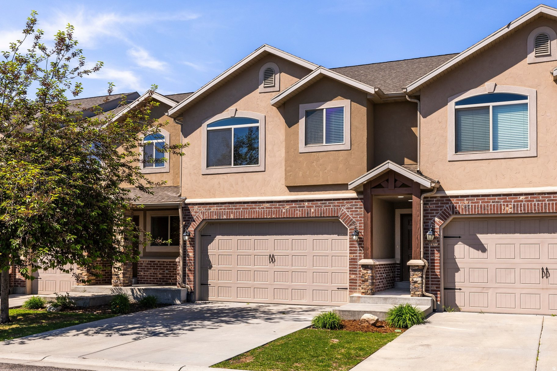 Tucked in the back of the community, this townhouse offers something the others don't. Open space behind it, extra parking out front, and a quieter, more private feel that's hard to find at this price. Brand new carpet freshly installed. Fully finished basement with a 1/2 bath. Could be used as a second family room, a dedicated home office, or a 4th bedroom depending on your needs. The covered back patio opens directly to open space, making it a genuinely functional place to host or unwind. Community playground on site. Minutes from Hill Air Force Base, I-15, Riverdale shopping, and everyday errands. This is the most finished, most private unit available in the community. It truly is a must-see in person!