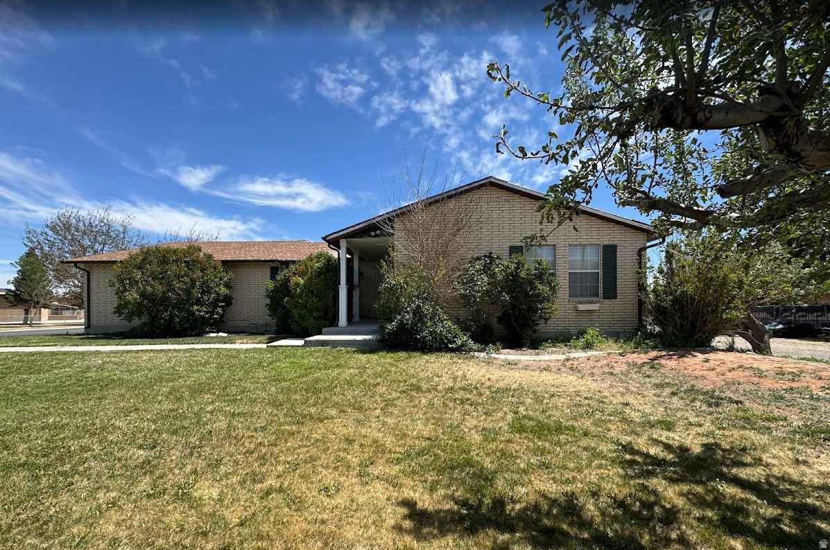 Welcome to your own outdoor paradise! This fully finished 6-bedroom, 3-bathroom home sits on a spacious .75-acre corner lot on a quiet, beautiful street next to the junior high and open fields, offering incredible space, privacy, and endless possibilities. With 2,800 sq ft and main floor living, the home features 3 bedrooms on the main level and 3 additional bedrooms downstairs, plus a large basement family room perfect for movie nights, a playroom, guests, or entertaining.  Enjoy cozy evenings with two fireplaces - one upstairs and one downstairs - creating the perfect atmosphere for cold winter days and holiday gatherings. The home has been updated with new paint, newer flooring in the upstairs bathrooms, and a newer roof. All bathrooms include bathtubs for added convenience.  The property is ideal for those needing extra parking and storage space. Bring your trucks, trailers, RVs, razors, snowmobiles, and toys - there's room for it all! The oversized lot also offers the potential to add a pickleball court, additional shop space, or even an ADU with Utah's updated ADU laws. A 220V charger is already installed in the garage for your electric vehicle.  Outside, enjoy mature trees, fruit trees (2 pear, 2 apple, and 2 peach trees), a chicken coop, dog pen, beautiful patio, and included trampoline. The property also features abundant storage with a dedicated food storage room, additional storage room, and shelving area perfect for gear and toys. Workbench and extra garage shelving are included. The Bullfrog Spa is only 3 years old and included with the home. Appliances are included, and couches and beds are negotiable.  Located just 2.5 miles from Millsite State Park and the Millsite Golf Course, this property offers direct access to outdoor adventure. Ride your four-wheeler straight into the desert, spend the day fishing near Green River just an hour away, or take a quick two-hour drive to Moab for world-class hiking and recreation. Clear skies, fresh air, biking, walking, and nature surround you here.  Also located just 45 minutes away from the famous San Rafael Swell.   No HOA. Pet-friendly area. A rare opportunity to own a home with space, storage, adventure, and flexibility all in one!