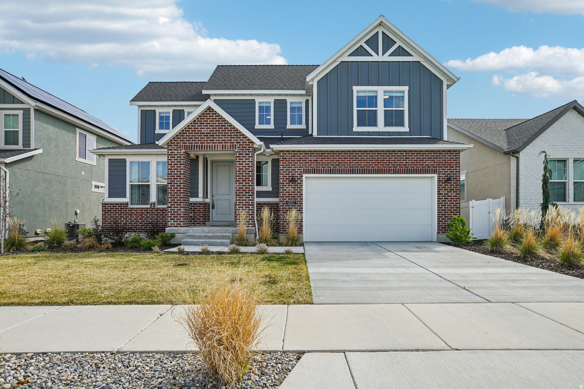Welcome to this stunning, like-new 2024-built home in the Hidden Oaks community of Herriman. This home combines modern elegance with functional design. The open-concept main floor features a gourmet kitchen with Silestone countertops, gas appliances, and a grand great room centered around a cozy fireplace-perfect for entertaining. Without losing the sweeping views of the Wasatch and mountains as you sit above the new homes built behind. The walkout basement, providing seamless indoor-outdoor living and endless potential for you to finish. Retreat to the primary suite with its spa-like bath and walk-in closet. Enjoy the private backyard patio and pergola and the convenience of schools located right in the neighborhood. Why wait for new construction when this turnkey gem is ready for you today. Mortgage savings may be available through the listing agent's in-house lender; ask for details.