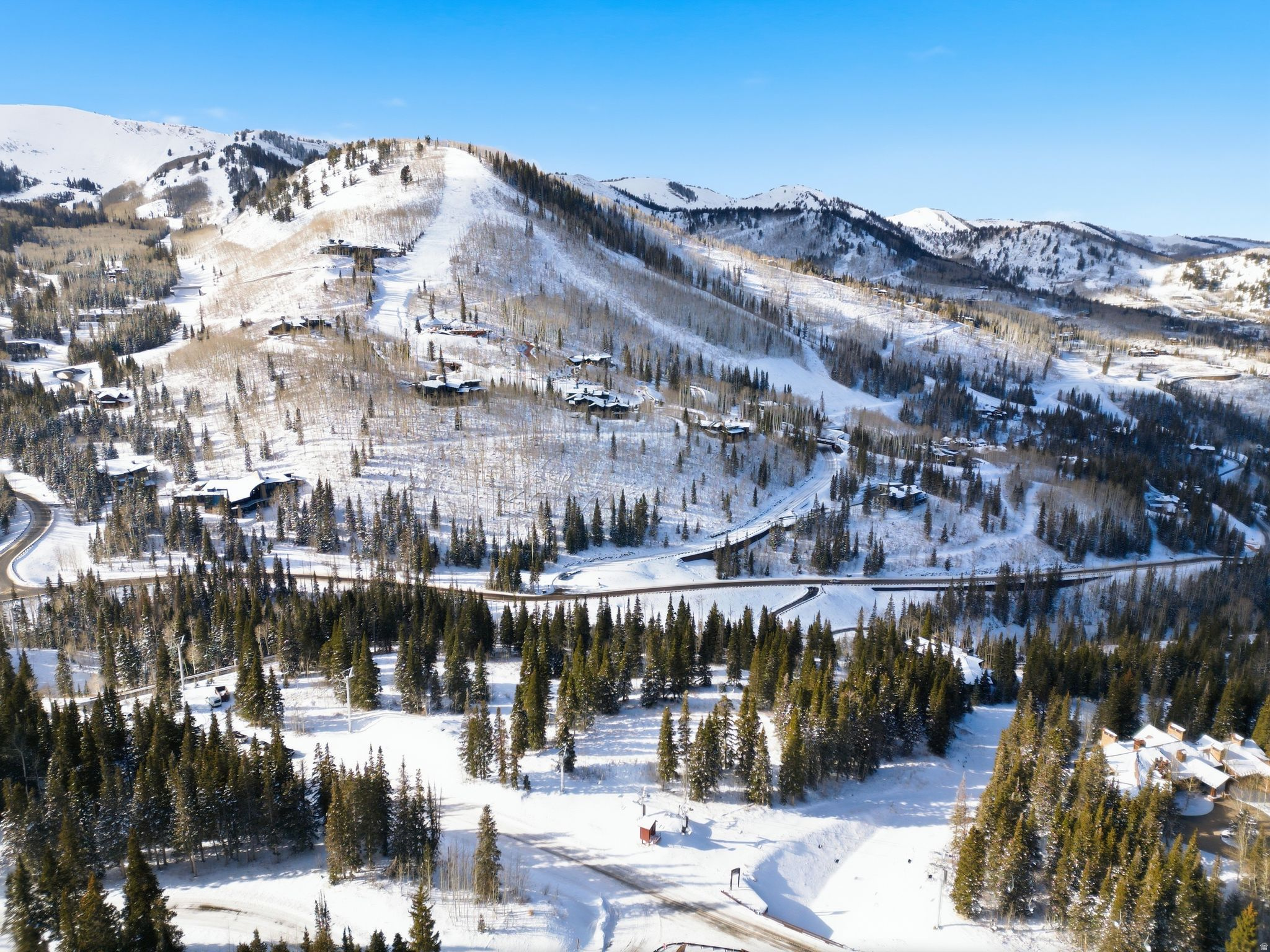 207 White Pine Canyon represents one of the final opportunities within The Colony to build a true ski-in/ski-out residence without compromise. The gently sloping parcel offers exceptional ski access to Park City Mountain Resort via the Blaise's Way and Snowonder runs, with seamless connections to the Dreamcatcher, Flat Iron, and Quicksilver Gondola lifts. The homesite is conveniently accessed by a relatively flat driveway corridor leading directly to the building envelope, allowing for both ease of arrival and thoughtful design flexibility. From the property, expansive views stretch almost 360 degress across the ski area to Iron Mountain and upward to South and West Monitor along the Park City ridgeline. The residence is also just moments from the soon-to-be-completed Private Colony Ski Lodge, an outstanding new amenity featuring full food and bar service. Far from just a vacant piece of ground, 207 White Pine Canyon includes plans for an extraordinary home Designed by the award-winning firm Backen & Backen that draws inspiration from the finest elements of 207 White Pine Canyon, reimagined as a timeless mountain estate that both delights the senses and sits harmoniously within its remarkable natural setting. The thoughtfully conceived plans present a rare opportunity to build a truly world-class estate-one that distinguishes itself even among the exceptional homes of The Colony at White Pine Canyon. Spanning more than 24,000 square feet, the design includes a grand main residence featuring nine luxurious bedroom suites, along with a connected Entertainment Barn offering an additional one to two bedroom suites. Fully engineered and approved, these plans are construction-ready, allowing the next owner to seamlessly bring this iconic vision to life. Whether your preference is to utilize the remarkable design from Backen & Backen or execute your own vision, 207 White Pine Canyon represents an awesome opportunity to create a world class mountain estate.