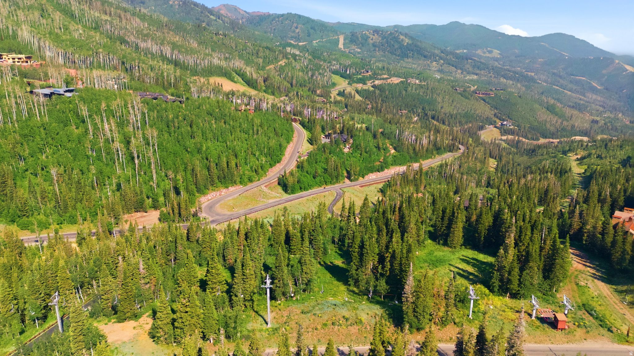 207 White Pine Canyon represents one of the final opportunities within The Colony to build a true ski-in/ski-out residence without compromise. The gently sloping parcel offers exceptional ski access to Park City Mountain Resort via the Blaise's Way and Snowonder runs, with seamless connections to the Dreamcatcher, Flat Iron, and Quicksilver Gondola lifts. The homesite is conveniently accessed by a relatively flat driveway corridor leading directly to the building envelope, allowing for both ease of arrival and thoughtful design flexibility. From the property, expansive views stretch almost 360 degress across the ski area to Iron Mountain and upward to South and West Monitor along the Park City ridgeline. The residence is also just moments from the soon-to-be-completed Private Colony Ski Lodge, an outstanding new amenity featuring full food and bar service. Far from just a vacant piece of ground, 207 White Pine Canyon includes plans for an extraordinary home Designed by the award-winning firm Backen & Backen that draws inspiration from the finest elements of 207 White Pine Canyon, reimagined as a timeless mountain estate that both delights the senses and sits harmoniously within its remarkable natural setting. The thoughtfully conceived plans present a rare opportunity to build a truly world-class estate-one that distinguishes itself even among the exceptional homes of The Colony at White Pine Canyon. Spanning more than 24,000 square feet, the design includes a grand main residence featuring nine luxurious bedroom suites, along with a connected Entertainment Barn offering an additional one to two bedroom suites. Fully engineered and approved, these plans are construction-ready, allowing the next owner to seamlessly bring this iconic vision to life. Whether your preference is to utilize the remarkable design from Backen & Backen or execute your own vision, 207 White Pine Canyon represents an awesome opportunity to create a world class mountain estate.