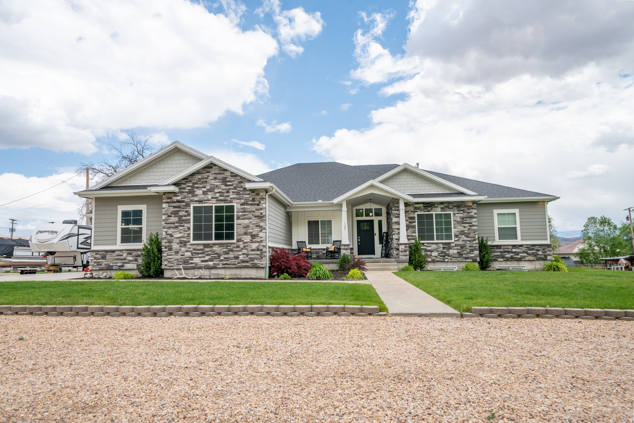 Experience the perfect balance of space, comfort, and small-town charm in this exceptional home built in 2018 and situated on 0.97 acres in a peaceful, picturesque community. Offering 5,177 sq. ft. of living space, this stunning property features 7 bedrooms, 3.5 bathrooms, two spacious family rooms, a formal living room, and a basement kitchenette, providing flexibility for entertaining, guests, or multi-generational living. The beautifully designed interior showcases vaulted ceilings, two cozy fireplaces, and an open, inviting floor plan filled with natural light. Every bedroom features its own walk-in closet, offering abundant storage and convenience throughout the home. The fully finished basement adds valuable living space and functionality, making it ideal for a variety of lifestyles. Outside, you'll find a massive oversized garage complete with a dedicated workshop area, providing ample space for vehicles, hobbies, and storage. An included ADU/rental property offers excellent income-producing opportunities or additional accommodations for family and guests. Surrounded by the beauty and tranquility of small-town living, this exceptional property combines modern construction, abundant space, and incredible flexibility. Whether you're looking for room to grow, space to entertain, or the added benefit of rental income, this one-of-a-kind property is ready to welcome you home.