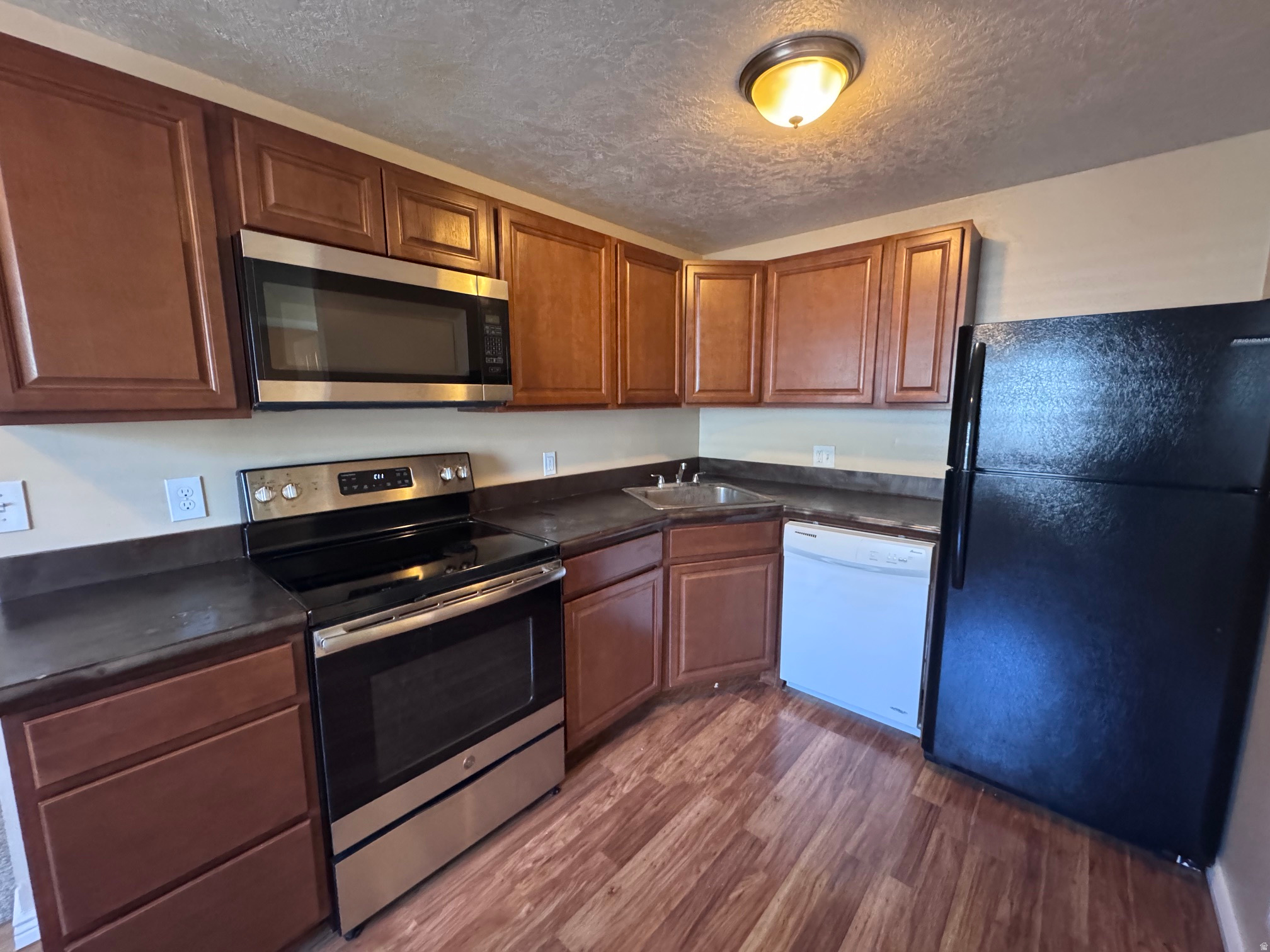 Discover easy living in this beautifully updated, top-level Roy condo! This 2-bed, 1-bath gem boasts a refreshed kitchen, laminate and tile flooring, a private balcony, and convenient parking right next to the unit. Perfect for commuters, you are just 5 minutes from Riverdale shopping, 6 minutes to the Roy FrontRunner Station, 7 minutes to Hill AFB, and under 15 minutes to Ogden. Enjoy a low-maintenance lifestyle with an HOA that covers water, sewer, and trash. Don't miss this turnkey opportunity!