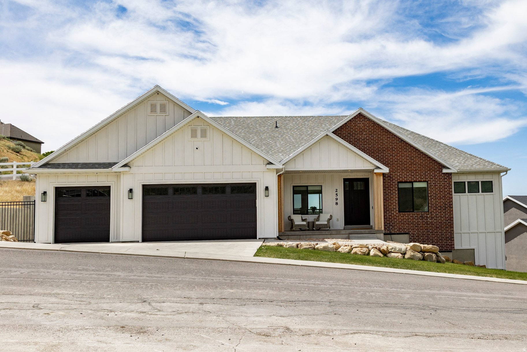 Custom home with an open-concept layout and a fully finished basement apartment featuring a separate entrance, full kitchen, laundry room, and three bedrooms. The basement also includes a dedicated theater room with surround sound and adaptive lighting. Vaulted ceilings create an open feel throughout the main living area, while the kitchen offers quartz countertops, soft-close cabinetry, an industrial refrigerator, and a walk-in butler's pantry. The spacious primary suite features vaulted ceilings, a private balcony, electric fireplace, and walk-in closet. Enjoy mountain views from the backyard complete with a large deck and waterfall feature. Additional highlights include permanent EverLights controlled through a mobile app for year-round customization. Conveniently located near Spanish Fork Golf Course, Spanish Oaks Reservoir, and an extensive network of hiking and biking trails. Buyer to verify all information, including square footage.