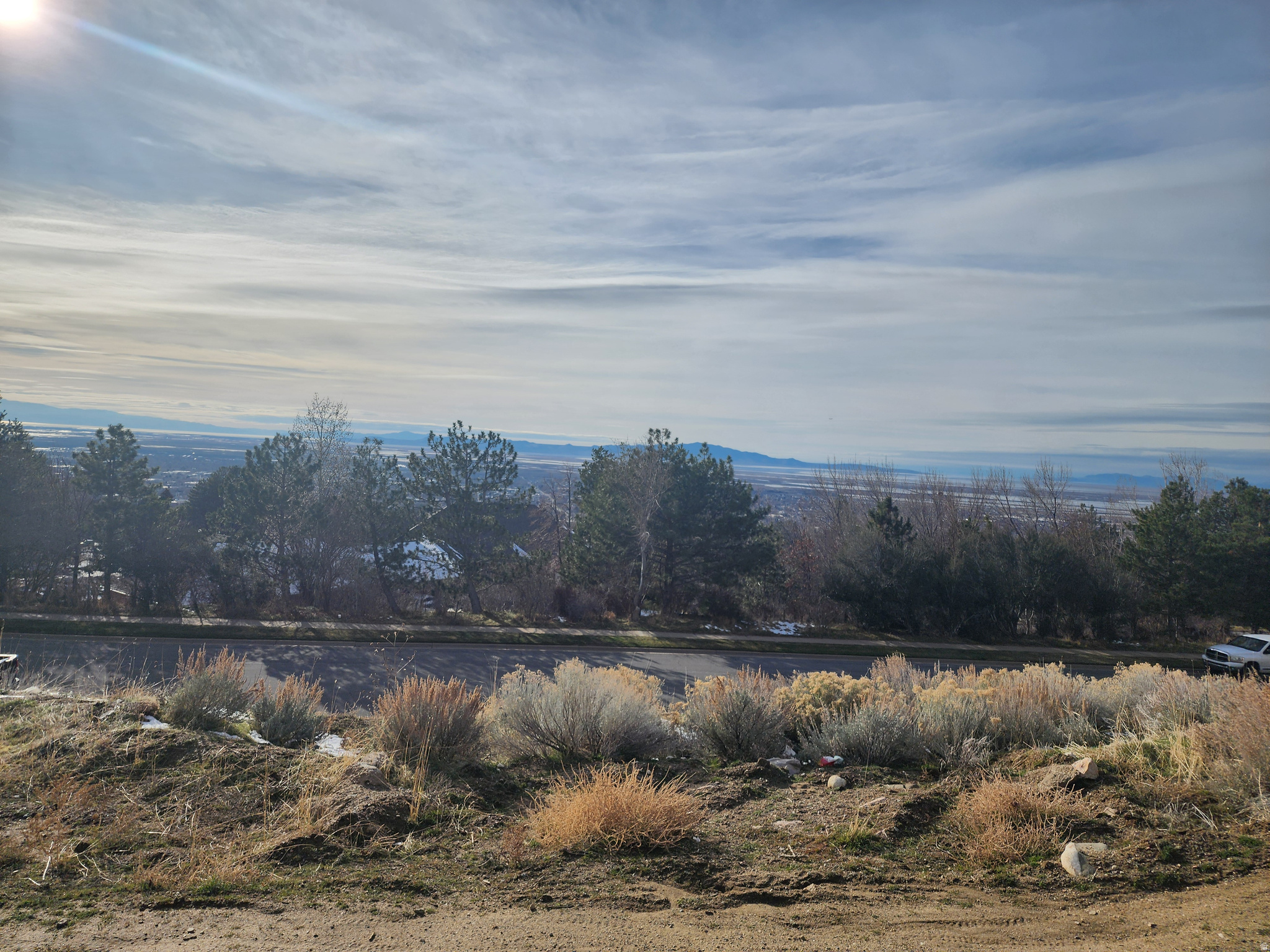 0.32-acre (13,940 SF) recorded subdivision lot on Bountiful's highly desirable east bench, located near the Bountiful Temple. This exceptional homesite offers remarkable valley and mountain views with an elevated setting that captures the beauty of the surrounding landscape. The lot's grade profile is well suited for a custom home design featuring a walk-out basement, drive-out garage, or lower-level access - creating excellent flexibility for layout, living space, and garage configuration. A rare opportunity to build a custom residence in an established subdivision with strong curb appeal and scenic surroundings. Utilities stubbed and ready for your custom build.