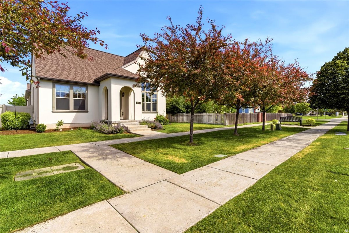 Welcome to this beautifully maintained rambler in the highly desirable Hill Farms community of Kaysville. Freshly painted and featuring brand-new carpet, this move-in-ready home offers a bright, inviting atmosphere with abundant natural light throughout. The thoughtfully designed floor plan provides comfortable living spaces for both everyday life and entertaining. The spacious main floor features genuine hardwood flooring, a cozy fireplace, and a bright kitchen with white cabinetry, abundant storage, and a generously sized pantry. Just off the kitchen, a private patio creates the perfect setting for al fresco dining and extends the living space outdoors. The primary suite offers a relaxing retreat, complete with its own fireplace and en-suite bathroom. The fully finished basement provides an expansive family room, generously sized bedrooms, and plenty of space for gatherings, hobbies, or just an extension of comfortable living space. Outside, you'll enjoy access to a spacious shared green space, perfect for outdoor activities, relaxing evenings, and neighborhood gatherings. A brand-new playground is located just a few doors away. Conveniently located with quick access to I-15 and the West Davis Corridor, this home is just minutes from shopping, dining, parks, and schools while maintaining the charm and sense of community that make Hill Farms such a sought-after neighborhood. The HOA takes care of lawn maintenance and snow removal, allowing you to enjoy low-maintenance living in a quiet, low-traffic community.