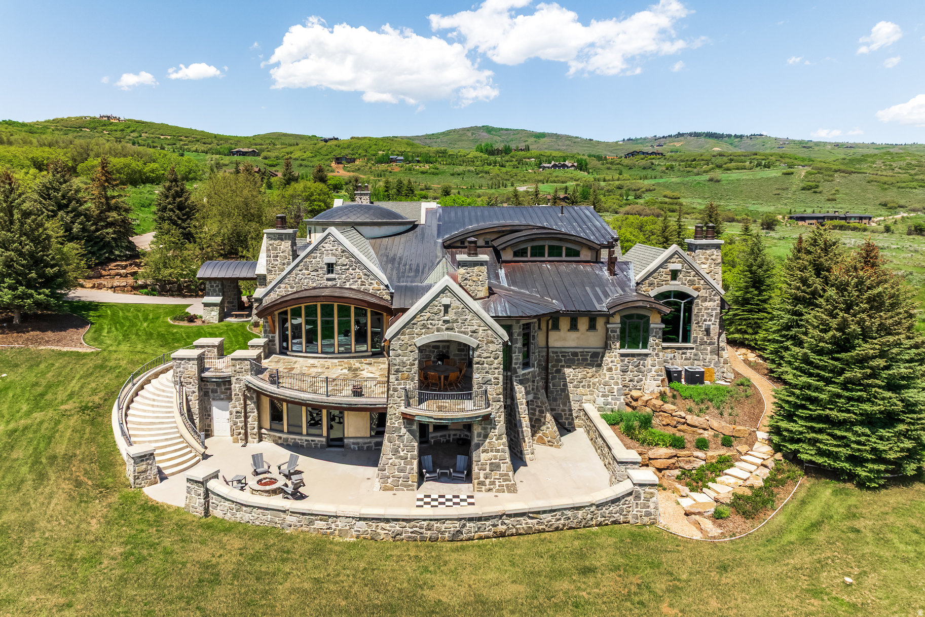 Introducing Greystone, one of Park City's most iconic mountain estates set on 12.4 private acres behind the gates of Glenwild-Park City's premier private golf community-this extraordinary legacy residence offers an unparalleled combination of architectural significance, privacy, and luxury. Offered at an exceptional value of $10,500,000, Greystone is priced well below today's replacement cost-an opportunity rarely found in Park City's luxury market. This is a chance to acquire an iconic estate at a compelling value while adding your own vision and style to its next chapter, all without the years, expense, and uncertainty of building new. Greystone offers the rare chance to become the next steward of a true legacy property while creating its next remarkable chapter. Designed by renowned architect Michael Upwall and meticulously crafted by Midway Construction, the 14,000 square-foot estate has recently undergone a sophisticated transformation with updated designer furnishings, contemporary color palettes, and curated dcor that create a fresh, modern mountain aesthetic while honoring the home's timeless architecture. Designed for effortless entertaining and comfortable everyday living, Greystone features five spacious bedroom suites, including an elegant main-level primary retreat and four private guest suites. An elevator connects all three levels, where expansive gathering spaces include six fireplaces, two executive offices, a richly appointed library, and a sun-filled conservatory. At the heart of the home, the chef's kitchen is appointed with Wolf, Sub-Zero, and Asko appliances, an oversized center island, and a fully equipped butler's pantry designed to accommodate intimate dinners or large-scale entertaining. The walkout lower level delivers an exceptional lifestyle experience with a private theater, game and billiards rooms, climate-controlled wine cellar, fitness center with steam room, and generous storage throughout. A heated five-car garage with RV parking, workshop, and a rare indoor sports court provides exceptional versatility for collectors, outdoor enthusiasts, and active families. Heated patios and driveway ensure year-round comfort and convenience. Perfectly positioned to capture breathtaking south-facing views of Deer Valley Resort and Park City Mountain, the estate is enhanced by an impressive collection of modern systems, including solar power, whole-home air and water purification, humidification, surround sound, central vacuum, fire suppression, programmable climate controls, and comprehensive landscape irrigation. Separate Membership to Glenwild Country Club is available, offering access to one of Utah's most celebrated private golf experiences. Membership is not required to live in the Glenwild community.