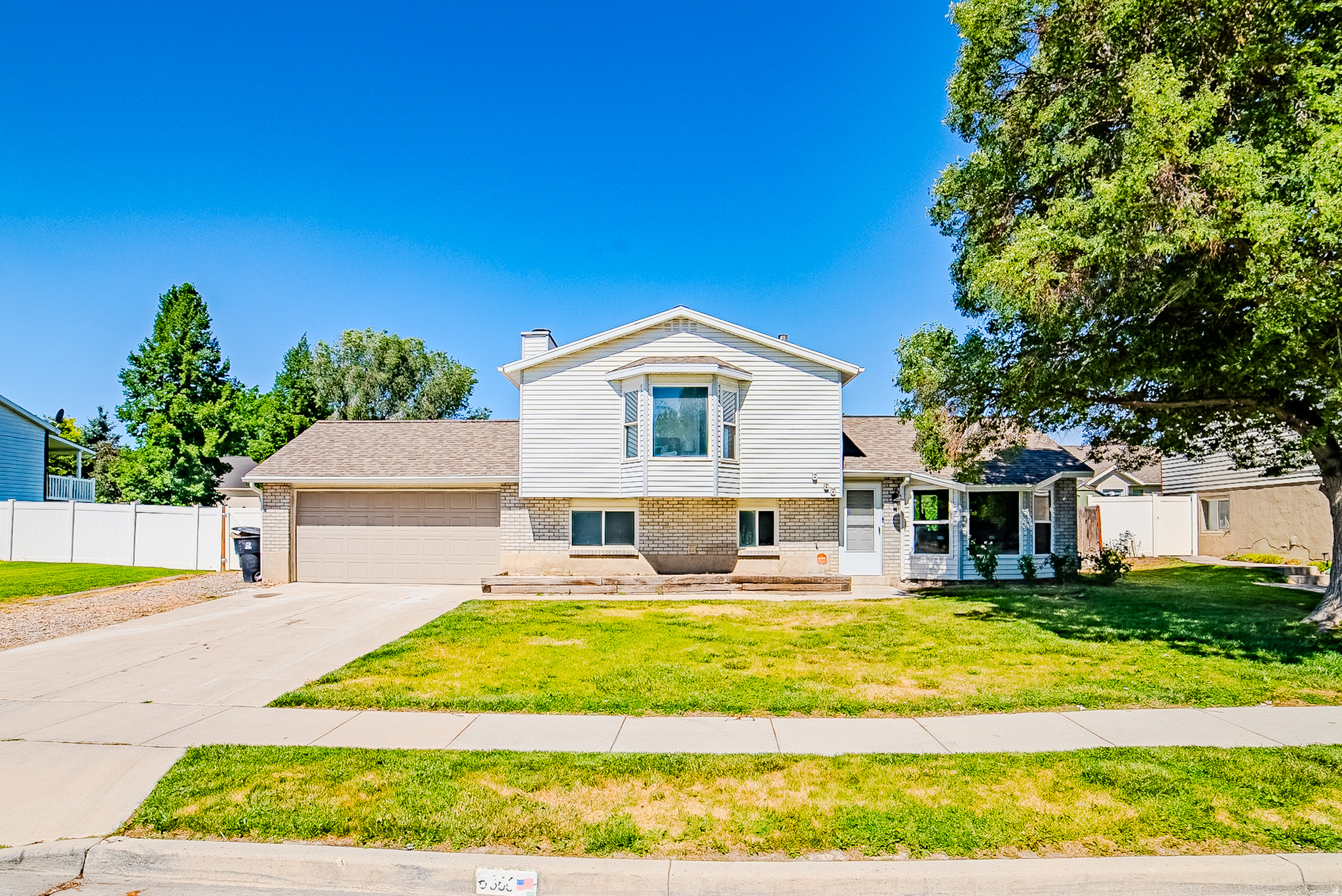 Welcome to this beautifully remodeled multi-level home offering the perfect blend of style, comfort, and convenience. Situated on a 0.17-acre lot, this move-in-ready property has been thoughtfully updated with modern finishes throughout.  Step inside to discover a bright, open living space with soaring ceilings, new flooring, fresh paint, and abundant natural light. The stunning kitchen features crisp white cabinetry, quartz countertops, subway tile backsplash, stainless steel appliances, and a spacious island that flows seamlessly into the dining area, making it ideal for everyday living and entertaining. The inviting family room offers a cozy fireplace and additional living space, while the updated bathrooms showcase modern tile, new vanities, and stylish fixtures. Outside, enjoy a fully fenced backyard with a covered patio, mature trees, and plenty of room to relax, garden, or host summer gatherings. Commuters will love the unbeatable location right off of Bangerter Highway and 6200 South, while only being minutes from I-215, providing quick access throughout the Salt Lake Valley. You're only 6 minutes from Jordan Landing, offering an abundance of shopping, restaurants, entertainment, and everyday conveniences. Within 10 minutes, you'll also find the Utah Olympic Oval, Utah First Credit Union Amphitheater, Murray Parkway Golf Course, parks, recreation, and more.  A beautifully updated home in an established neighborhood with an unbeatable location. This is one you won't want to miss!  Buyer is advised to independently verify all measurements and property information to their satisfaction.