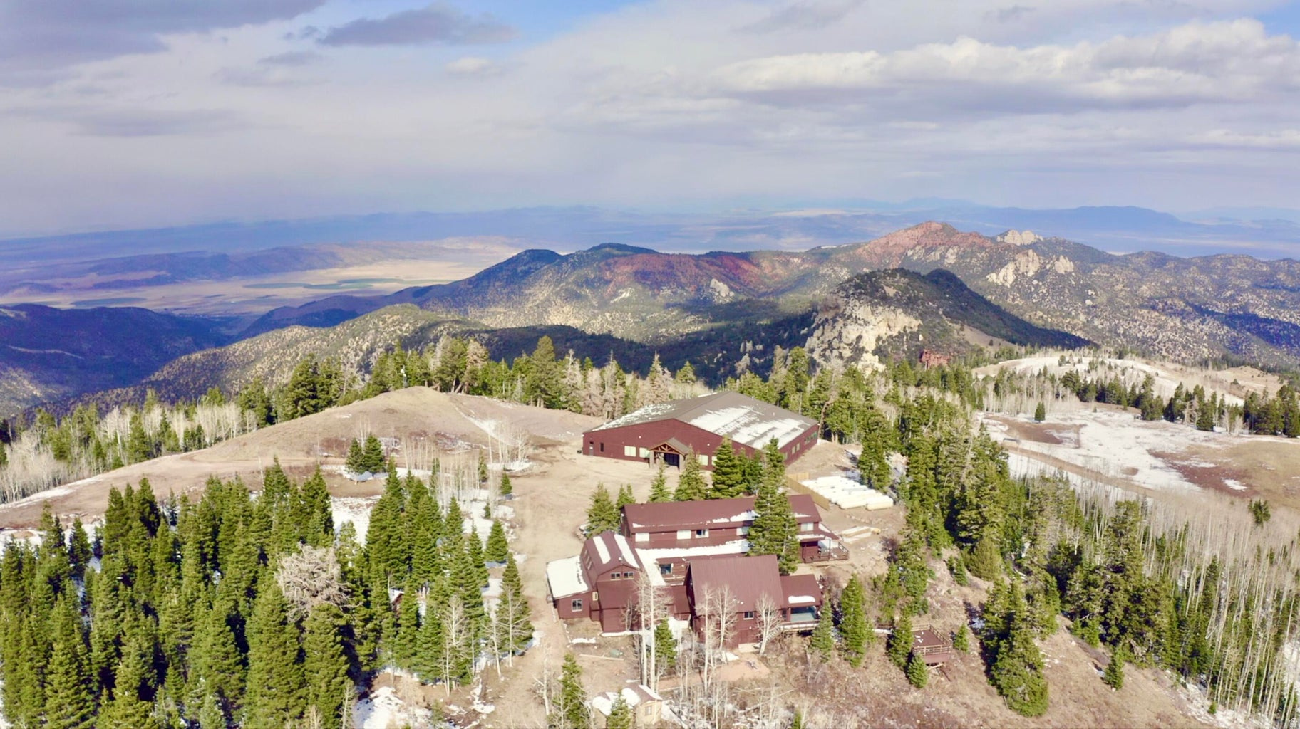 Stunning Mountain Retreat on 60.19 Acres! This incredible mountain property features a massive 11,263 sq. ft. cabin with a game room, large gathering room, 12 bedrooms, multiple bathrooms, and a walk-in freezer. Enjoy the expansive deck area with breathtaking overlooks, plus an impressive 13,000 sq. ft. activity center complete with a full gym. Multiple propane tanks and culinary well add convenience and functionality. Ideal for family reunions, corporate retreats, weddings, and special events, this peaceful mountain setting offers the perfect place for relaxation and unforgettable gatherings.