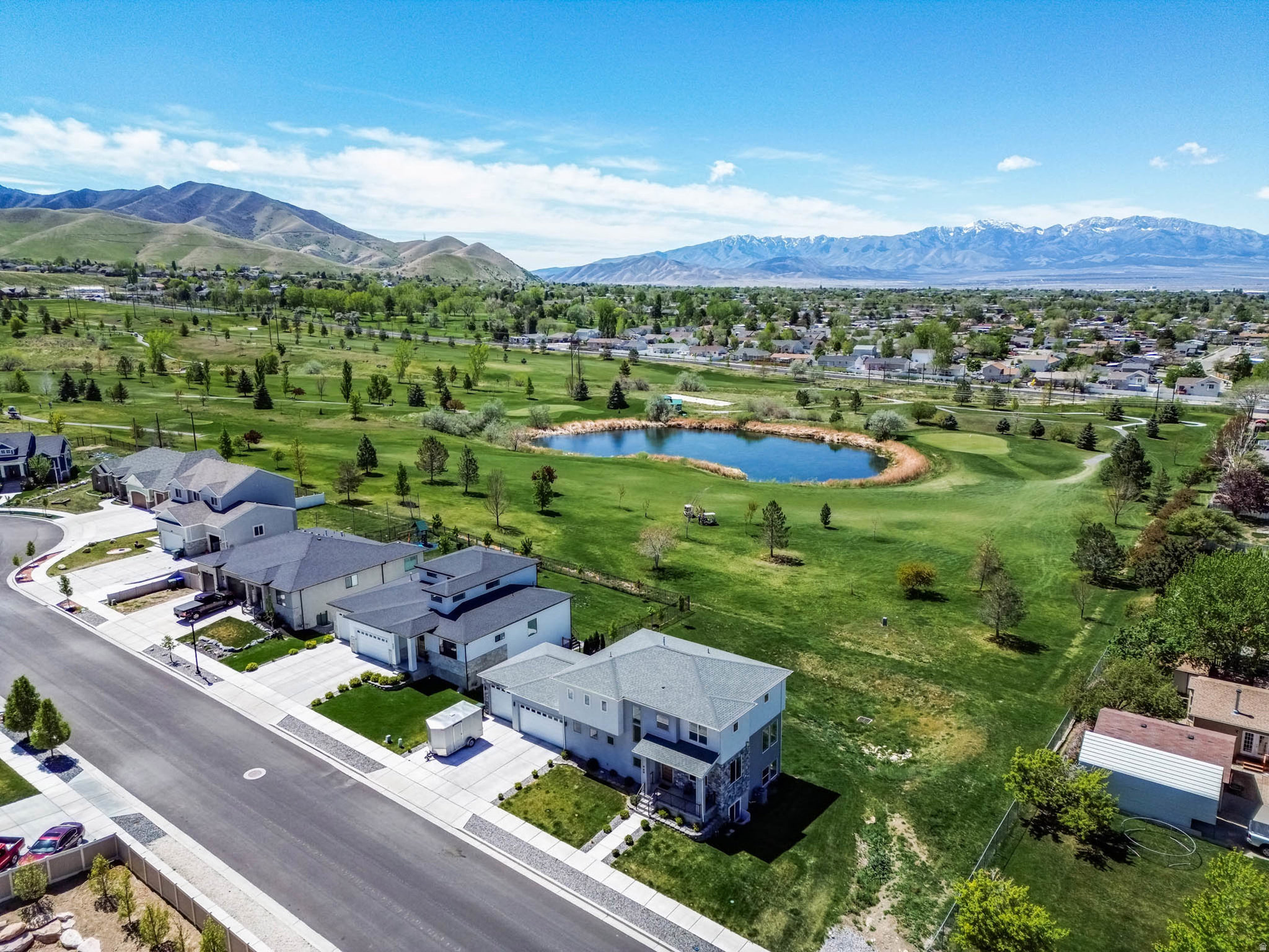 Stunning Fully Finished Home on the Golf Course with Breathtaking Views! Welcome to this beautifully finished home perfectly situated on a quiet cul-de-sac, backing directly to the golf course with incredible views of the mountains and lake. Designed for both comfort and style, this home features oversized windows throughout that flood the space with natural light. The spacious open-concept layout includes a large kitchen and great room. Retreat to the luxurious master suite complete with a spa-like bathroom featuring double sinks, a standalone soaking tub, a large shower, and a generous walk-in closet. Enjoy year-round comfort with insulated blinds and dual furnace systems. The extra-wide and deep garage offers plenty of room for vehicles and storage, complete with epoxy floors and a 240V outlet ready for an electric vehicle. The fully finished basement boasts impressive 10-foot ceilings and abundant natural light. Step outside to your private backyard oasis with a covered patio, gas fireplace, outdoor lighting, and plumbing for a natural gas barbecue-perfect for relaxing or hosting. This home truly has it all-views, upgrades, and an unbeatable setting. Don't miss your chance to make it yours! Square footage figures are provided as a courtesy estimate only and were obtained from a previous listing.  Buyer is advised to obtain an independent measurement. Buyer and Buyer's Agent to verify all information.