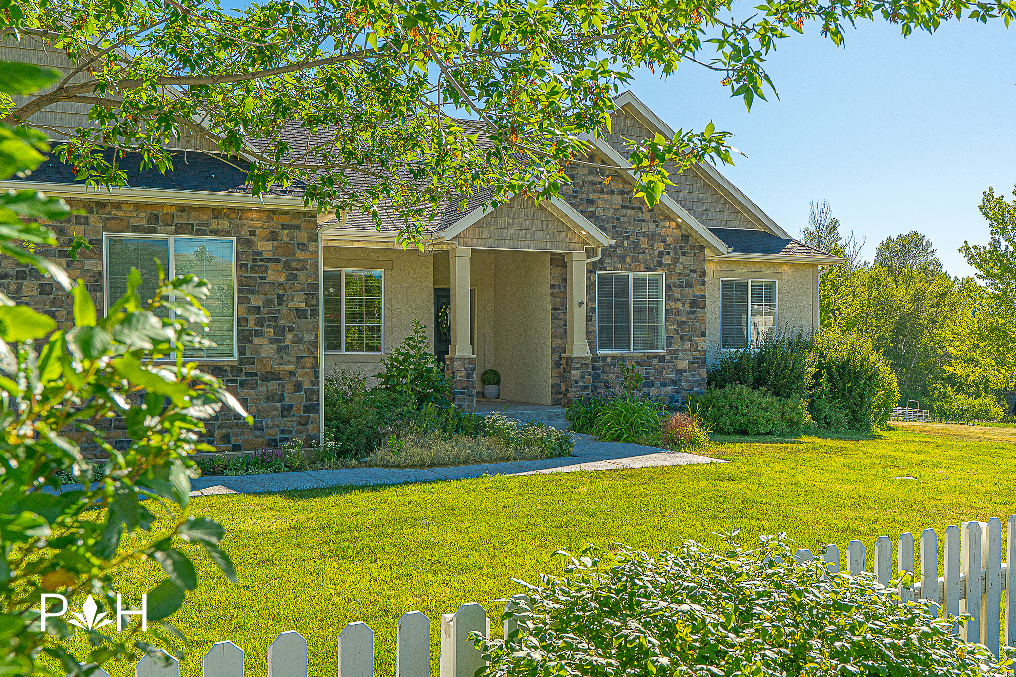 Looking for a stunning country home that is already established, turnkey, and situated on spacious acreage? Your search ends here! Built in 2015, this Richmond residence has been thoughtfully designed with a focus on space, comfort, and entertaining. As you arrive, you'll be greeted by a picturesque drive through the private Nebo Creek Estates bridge, leading you to a spacious driveway that offers plenty of parking for all your vehicles and recreational toys. Step inside the main level, where an inviting great room effortlessly connects the family, dining, and kitchen areas, creating an ideal space for gatherings. Thoughtfully placed windows bathe the area in natural light for all-day sunshine, enhancing the elegant and cozy ambiance. A convenient half bath for guests is nearby, along with direct access to the back patio, which is perfect for entertaining. Here, you'll find a large gazebo, a plumbed gas line, and a private setting where you can soak in the fresh mountain air. This level also includes a laundry room, two additional bedrooms, a full bathroom, and a tranquil primary ensuite. The primary ensuite is a true retreat, featuring luxurious marble tile work, an oversized jetted tub, a stunning glass shower, and a dual vanity for added convenience. Venture down to the basement, where you'll discover the home's second kitchen, an expansive family/recreation room, a den, three more bedrooms, abundant storage space, and another full bathroom. Don't forget about the already installed water softener and radon mitigation system so you can move in with true peace of mind. The home's three-car garage is fully painted and finished with a speckled epoxy flooring, as well. Set on 2.35 acres, this remarkable property comes with multiple outbuildings, including a barn-style shed, a chicken coop, a three-stall barn, corral paneling, and an additional shed. The sale also includes one water share and one water right, enhancing the potential of this incredible estate. Don't let this exceptional opportunity slip away! Embrace the lifestyle you've always wanted in this beautiful country home. All information has been provided as a courtesy to Buyer. It is the Buyer and Buyer Agent's responsibility to verify all information and listing data to their own satisfaction.