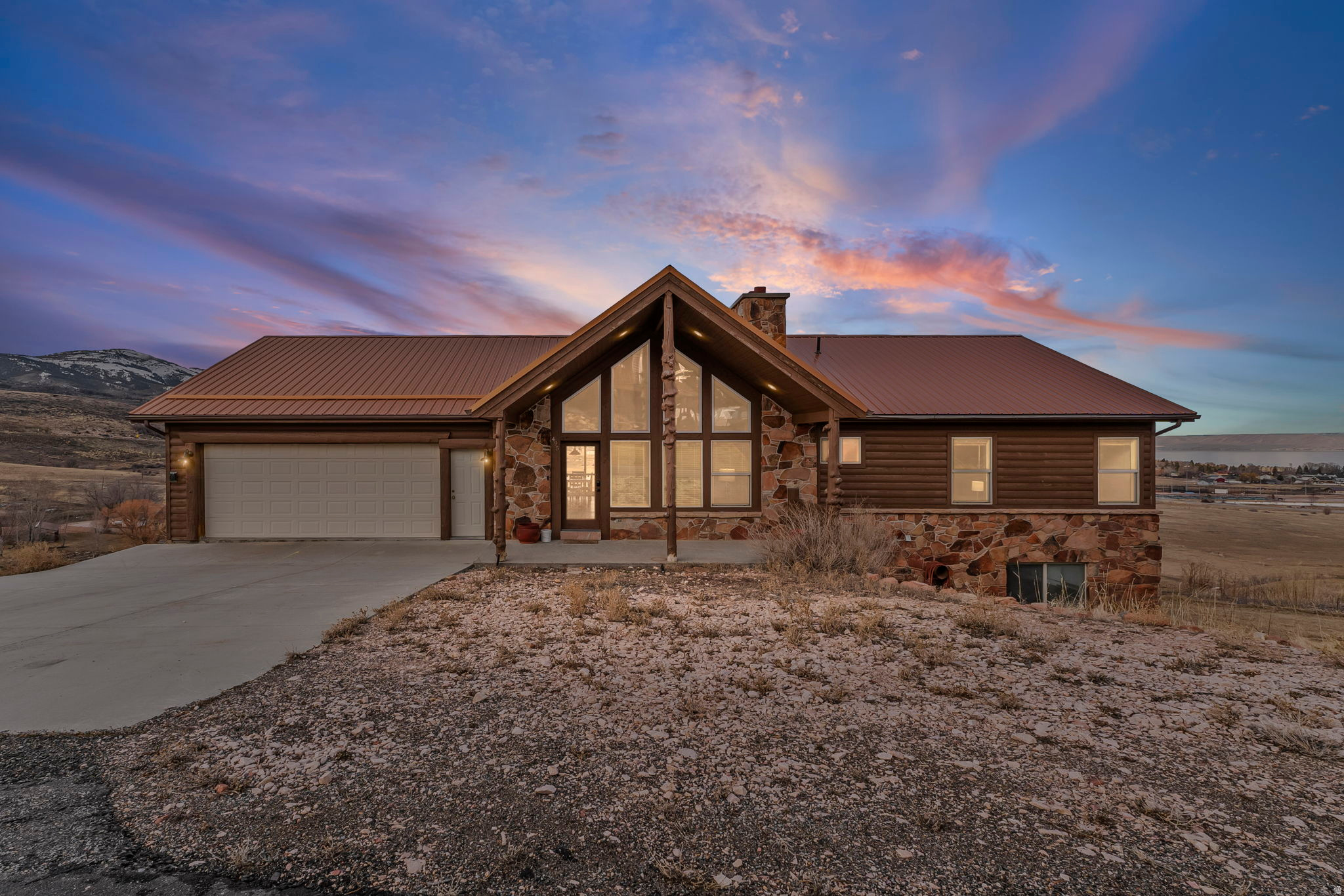 Garden City Getaway | Mountain & Lake Views | Sleeps 16+  Positioned along the shores of Bear Lake in Garden City, this expansive 5-bedroom, 4-bathroom retreat delivers panoramic mountain and water views with accommodations for 16+ guests. Designed for multi-generational gatherings, executive retreats, or high-capacity vacation rental income, this property offers the ideal blend of comfort, recreation, and proximity to year-round attractions.  The open-concept interior features a fully equipped kitchen with stainless steel appliances, oversized dining space, breakfast bar seating, Smart TVs, fireplace, jetted soaking tub, and multiple shower/tub combinations. A well-designed sleeping configuration includes a California King suite, multiple queen bedrooms, and a dedicated bunk room to maximize occupancy and flexibility.  Step outside to a furnished deck and patio area perfect for entertaining, complete with gas grill and outdoor dining - all framed by unobstructed lake and mountain vistas.  Property Highlights   5 Bedrooms | 4 Bathrooms | Sleeps 16+   California King primary suite   Dedicated bunk room with 4 Twin/Queen bunks   Central A/C & high-speed WiFi   Garage parking (2 vehicles) + street parking   Accessible-height toilets & grab rails in select baths   Keyless entry  Location & Lifestyle  Minutes from:   Bear Lake State Park   Pickleville Playhouse Theatre   Beaver Mountain Ski Area   Marina access, boating, fishing, golf, hiking trails, and winter recreation  This is a true four-season destination - boating and beach days in summer, vibrant fall colors, snowmobiling and skiing in winter, and peaceful spring fishing trips.  Whether positioned as a short-term rental asset or private family retreat, this Bear Lake getaway offers strong occupancy potential driven by proximity to skiing, theater, state park access, and marina recreation.  For private details, revenue projections, or showing requests, contact today.