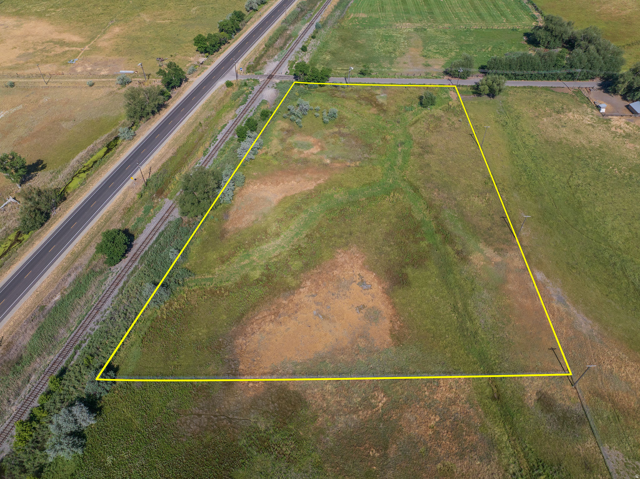 Exceptional 5.75-acre corner parcel offering outstanding frontage and visibility along Highway 13 and 1175 West in Brigham City's rapidly expanding industrial and commercial corridor. Ideally positioned near Interstate 15, Brigham City Municipal Airport, Union Pacific rail infrastructure, and major employers including Nucor Steel, this property presents an exceptional opportunity for investors, developers, owner-users, and businesses seeking a strategic Northern Utah location. Currently utilized as agricultural land, this generally level parcel offers excellent access, visibility, and long-term investment potential. While this property stands on its own, it is also located within the same development corridor as other nearby available parcels, creating opportunities for buyers seeking additional acreage or future assemblage potential. Contact the listing agents for additional development opportunities in the immediate area. Buyer to independently verify zoning, permitted uses, utility availability, water rights, easements, access, and all development requirements with the appropriate governmental agencies.