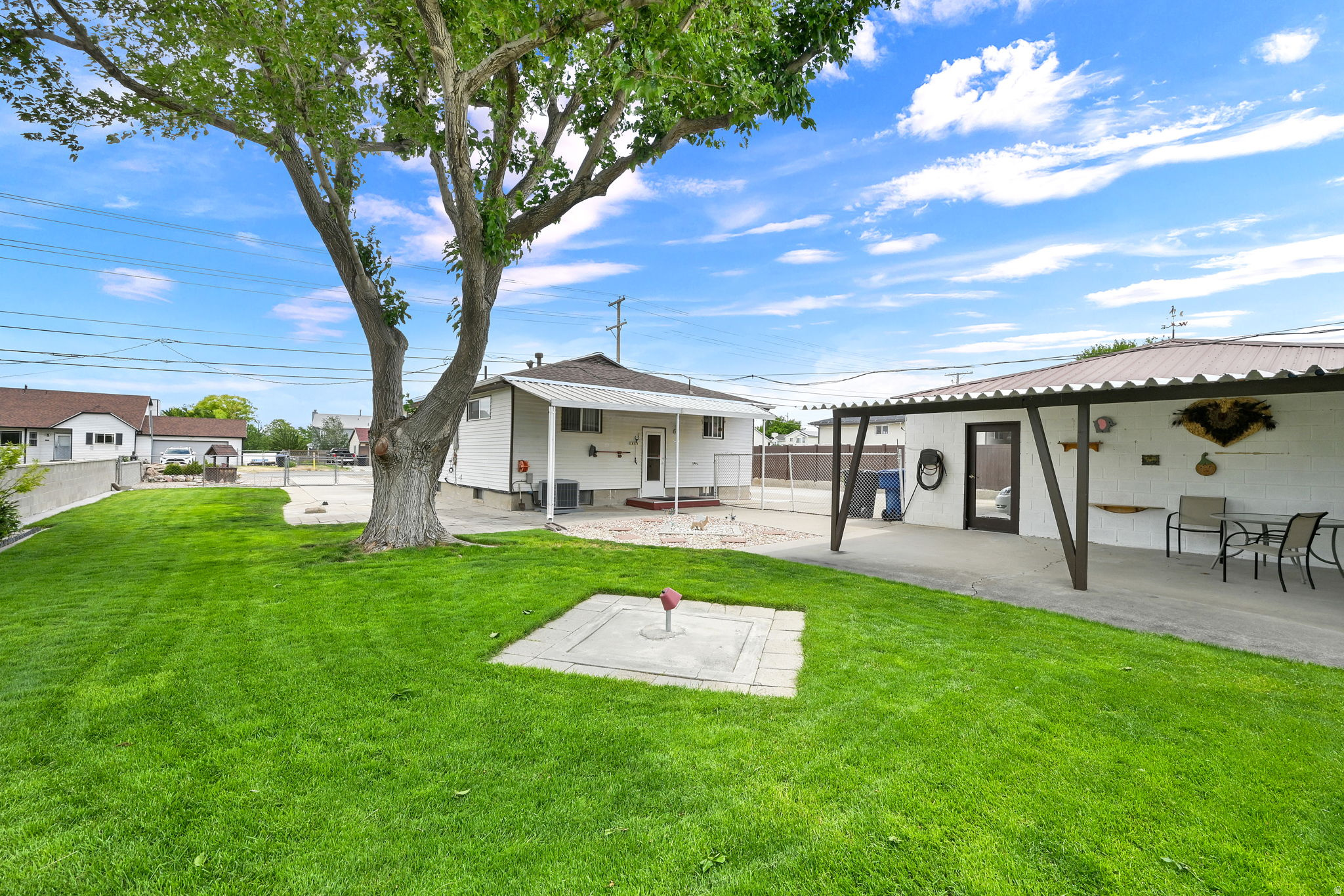 This is the first time this property has ever been for sale!  Land is getting scarce so owning almost a half acre property is incredible at this price, and it comes with a house! Plus a 3 car garage with a mechanics pit, a huge attached workshop in the back of the garage, two concrete driveways on each side of the house with rock in-between making it a circular driveway so you NEVER have to back into the street. RV parking, a pull through garage bay allowing you to haul bigger items in the backyard. There are two fenced yards. The backyard closest to the home is nicely manicured with lawn, bushes, gardens, two covered patios and perfect for relaxing or entertaining. The back gate to that yard leads to a much bigger fenced area with lawn, gardens, fruit trees, and a large outbuilding that securely stores mowers and garden equipment. Stop paying storage fees! Add an ADU! Grow your on food! The skies is the limit for the money saving ideas with this property and again...it comes with a house! The home has a new total tear-off asphalt shingle roof, central air, over 2000 finished sq ft of living space, all kitchen appliances stay including the washer/dryer. The sellers loved and cared for the property for 65 years. Buyer to verify all to satisfy themselves. As far as we know everything works and is in good order. At this price the property is being sold as-is.