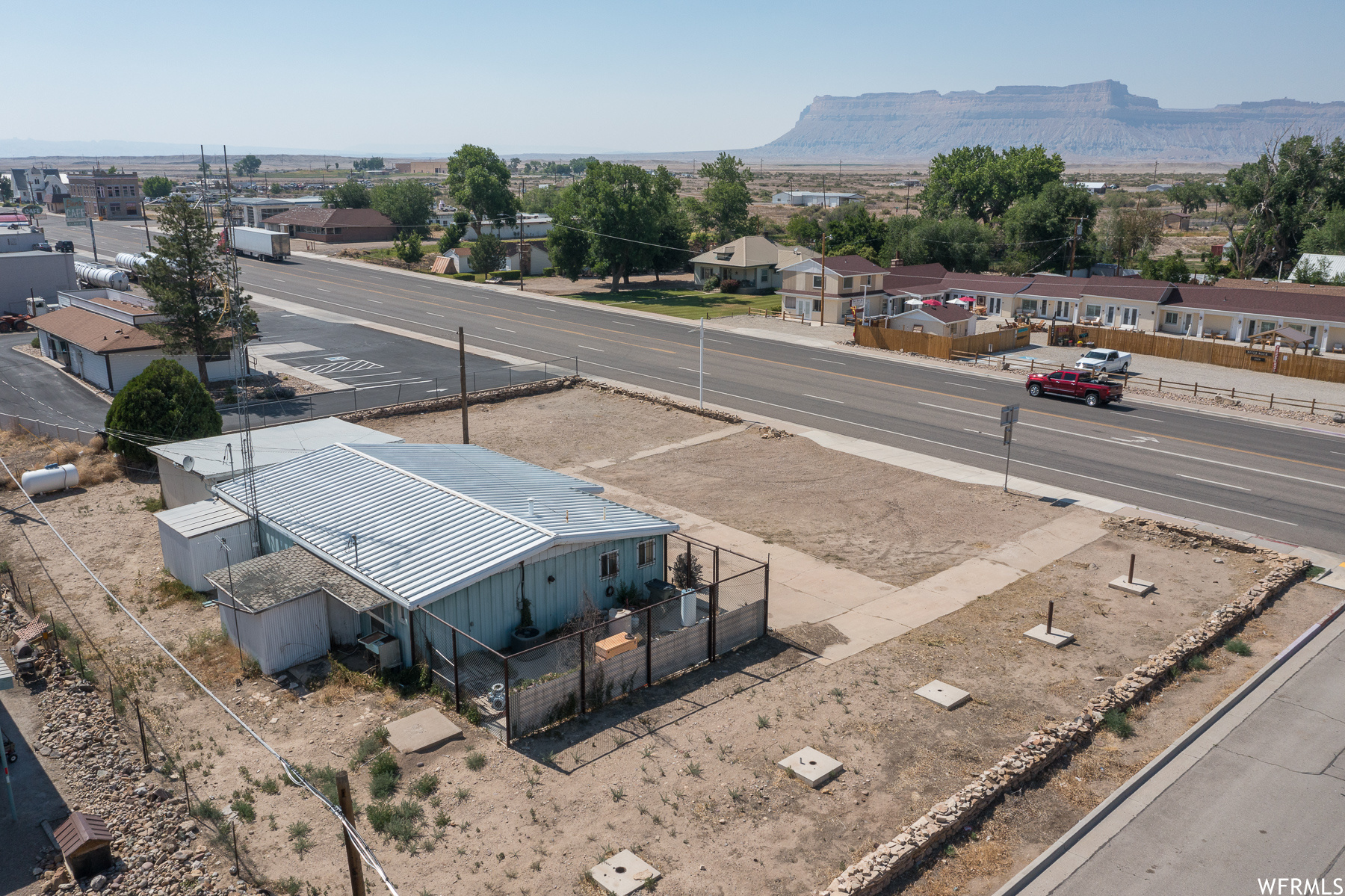 Corner lot on Main Street in downtown Green River.  Prime commercial location. This building has been used for a range of commercial purposes.  There are four large rooms in addition to a full kitchen, bathroom and shower room with central air.  Washer and dryer are included. Two car carport as well as storage rooms around the building.  120/240 V 3 phase electric.