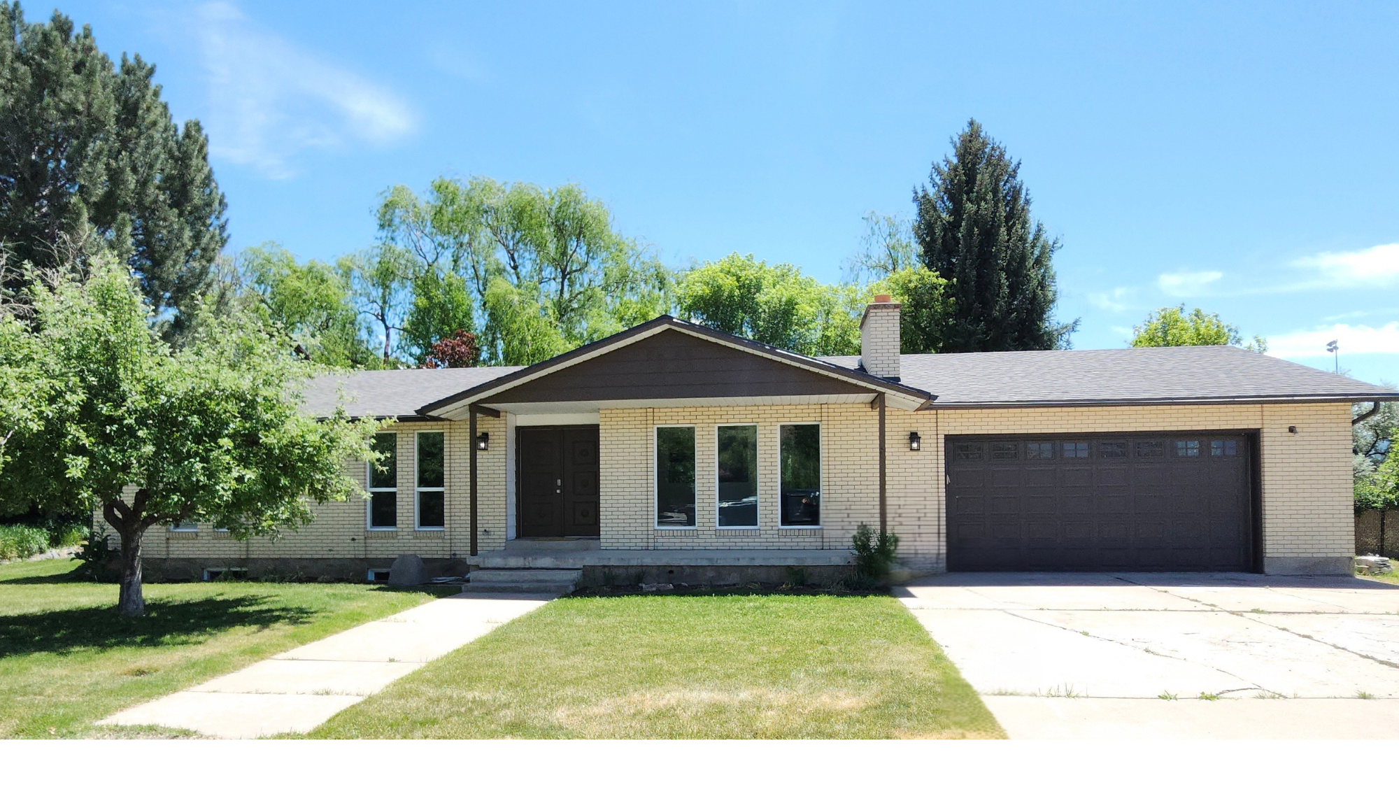 Welcome to your own private retreat on the Weber River! Nestled at the end of a quiet cul-de-sac subdivision, this stunning 5-bedroom, 3-bathroom brick home offers 2,918 sq ft of comfortable living space plus a rare combination of mountain views, water views, and true waterfront access, all on a secluded .32-acre lot. From the moment you arrive, the lush, mature landscaping sets the tone featuring majestic trees, a vegetable garden, and a fully irrigated yard with automatic sprinklers. Whether you're relaxing on the covered patio or soaking in the open-air space by the river, the serene surroundings create a one-of-a-kind outdoor living experience.  Inside, the thoughtfully updated kitchen shines with quartz countertops. All bathrooms have been beautifully updated with showers and/or bathtubs and surrounds. The finished full basement expands your living and storage options dramatically, while the oversized attached garage features extra width, extra length, an automatic opener, and room for your RV.