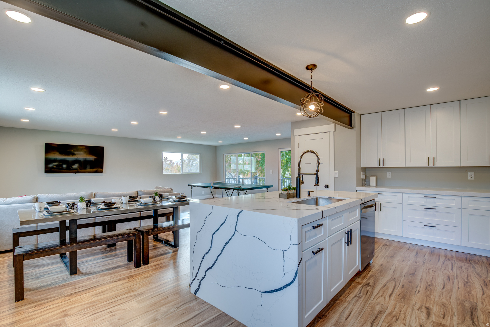 Fully renovated in 2023, this 5-bedroom, 3-bathroom home offers exceptional flexibility for a wide range of buyers, whether you're looking to continue a successful short-term rental, generate long-term income, accommodate multi-generational living, or live upstairs while offsetting your mortgage. Currently operating as a highly rated Airbnb with a 4.97-star average and over two years of proven performance, it holds "Guest Favorite" recognition and Superhost status, offering a rare opportunity to step into a turnkey, income-producing property, with the seller open to transferring the Airbnb listing, review history, Superhost status, and established property management automations for a seamless transition, while furnishings are negotiable. Inside, the spacious layout features multiple indoor living areas designed for comfort, connection, and entertaining, along with a full second kitchen, second laundry area, and a separate basement entrance, with the basement configurable as a 1- or 2-bedroom apartment, allowing a flexible setup that can accommodate up to 14 guests. The backyard is designed for both guest enjoyment and everyday living, featuring a hot tub with bistro lighting, a sport court for pickleball or basketball, a fire pit gathering area, and a large yard with patio dining and BBQ space, with the lawn set to be freshly seeded this spring. Ideally located just minutes from canyon access, parks, shopping, and freeway connections, this home appeals to both short-term guests and full-time residents alike, with proven 2+ year income history available upon request.