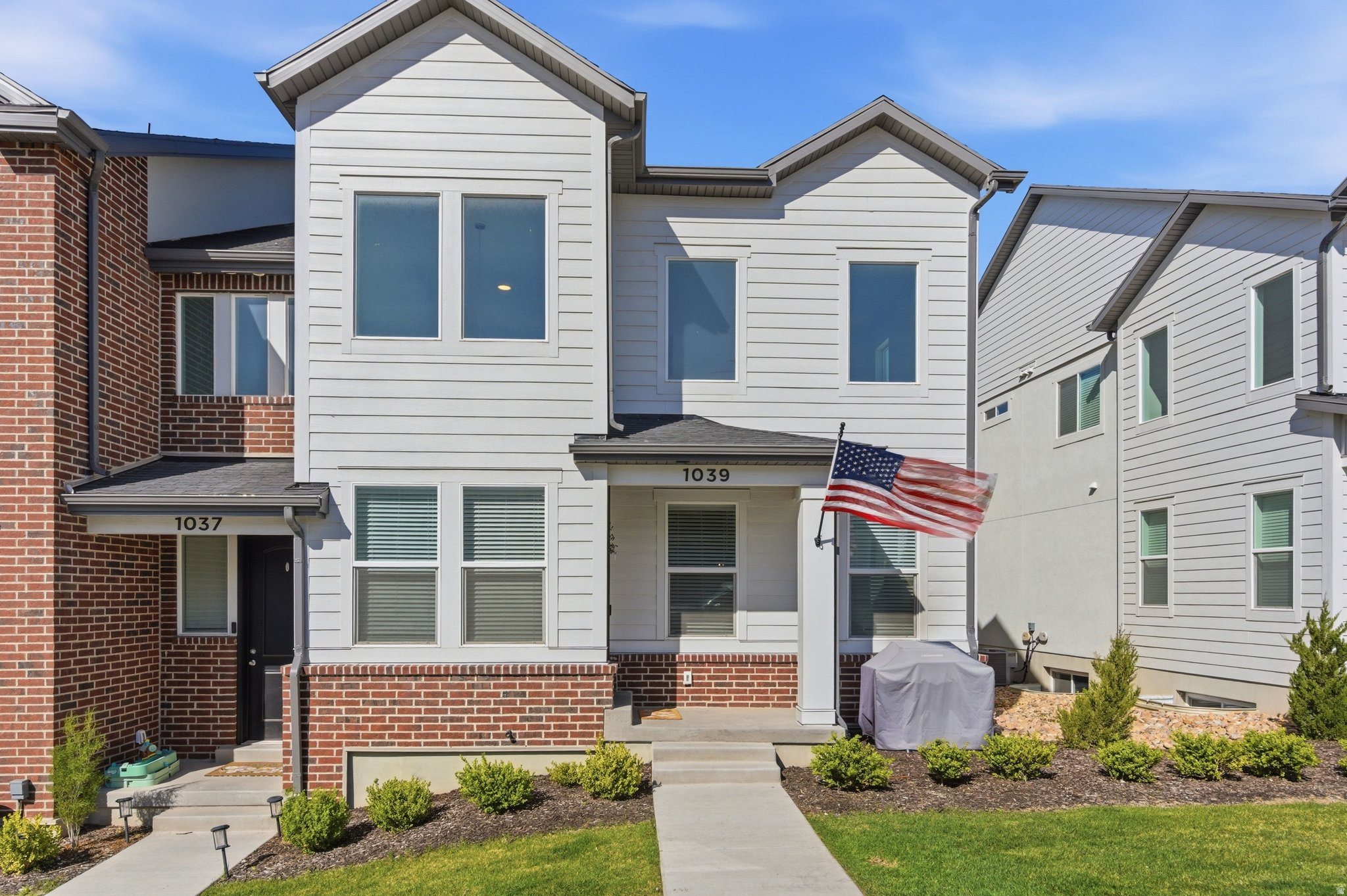 HIGHLY COVETED END UNIT LOADED WITH PREMIUM UPGRADES!! This stunning end-unit townhome showcases the builder's largest and most open floor plan, creating an impressive sense of space with soaring two-story ceilings, oversized windows, and abundant natural light. The thoughtfully designed open-concept layout is ideal for entertaining, seamlessly connecting the spacious great room, dining area, and beautifully upgraded kitchen. Premium finishes include quartz countertops, striking black shaker cabinetry, luxury vinyl plank flooring, designer pendant lighting, matte black fixtures, stylish metal stair railings, and a large center island with seating. -The spacious primary suite features vaulted ceilings, a luxurious en-suite bathroom with dual vanities, and an oversized walk-in closet. Additional highlights include an upstairs laundry room, generous secondary bedrooms, an unfinished basement ready for future expansion, a two-car garage, and ample guest parking.  -Enjoy breathtaking mountain views from this quiet community, just minutes from Mountain View Corridor, Saratoga Springs, shopping, dining, and The Ranches Golf Club. The HOA covers yard maintenance and snow removal, providing truly low-maintenance living.