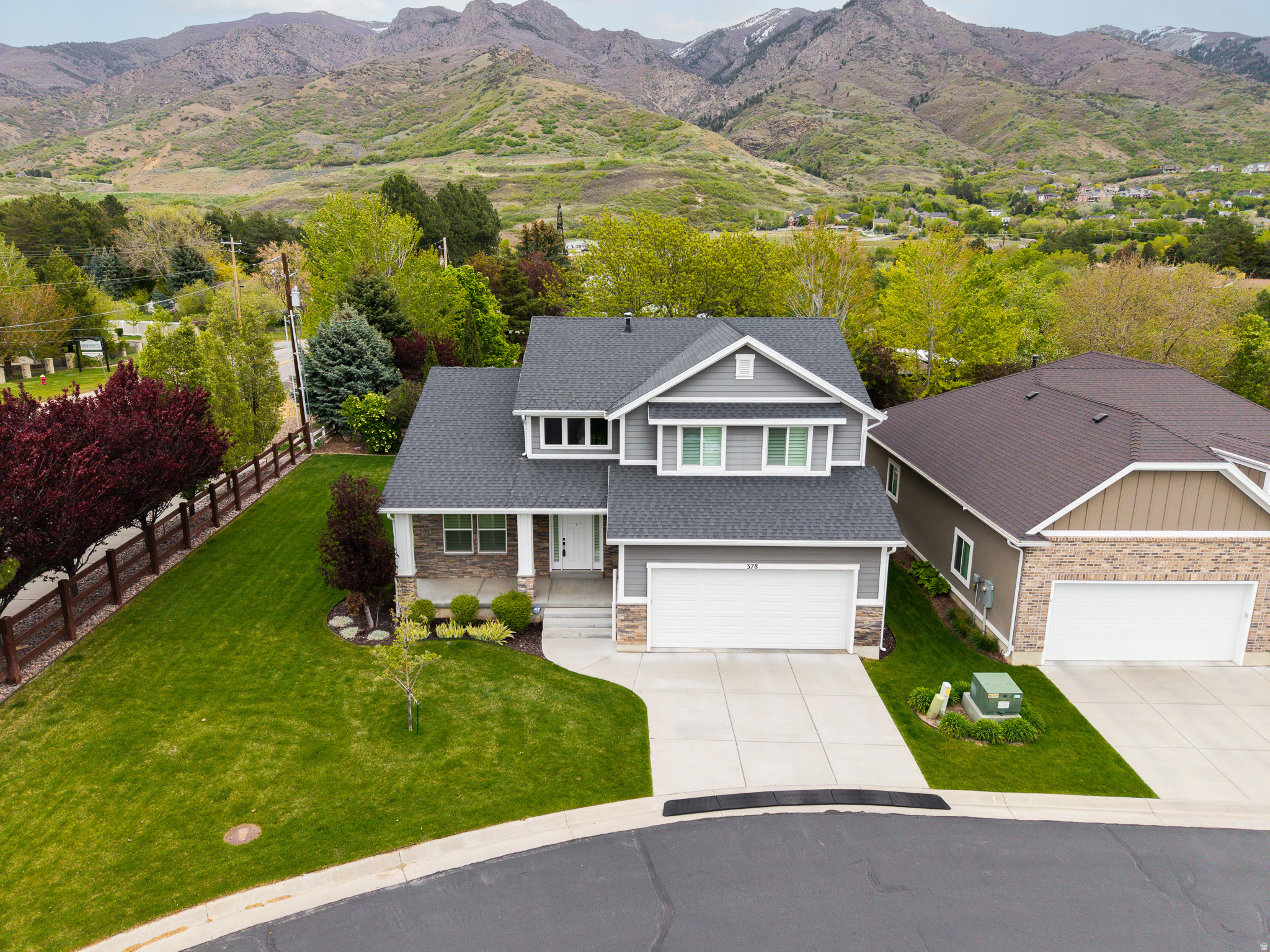 Experience an elevated standard of living in this refined East Layton residence, where sweeping mountain vistas and a luminous, two-story great room create a striking sense of arrival. Bathed in natural light and anchored by an inviting fireplace, the living spaces blend sophistication with effortless comfort. At the heart of the home, a thoughtfully designed, open-concept kitchen showcases upscale finishes, abundant storage, and seamless flow into the main gathering areas-ideal for both intimate evenings and gracious entertaining. Timeless design elements and carefully curated details throughout lend a sense of understated luxury. Designed with convenience in mind, the home offers true main-level living, featuring a serene primary suite and essential amenities all on one floor. The suite itself provides a private retreat, complete with generous proportions and spa-inspired features. Step outside to discover a private green space adjoining the home-an increasingly rare feature that offers both tranquility and a sense of openness. It's the perfect backdrop for quiet mornings or relaxed evenings, framed by the natural beauty of the surrounding foothills. For those drawn to an active, outdoor lifestyle, direct proximity to the foothills provides immediate access to an extensive network of hiking and biking trails. Meanwhile, exceptional connectivity ensures you are never far from your next destination: freeway access is just minutes away, placing Salt Lake City International Airport within a convenient 25-minute drive, and world-class ski resorts a mere 30 minutes from your doorstep. What truly sets this property apart is its lifestyle-driven setting within a meticulously maintained HOA community. Here, the demands of homeownership are elegantly simplified. Professional landscaping, seasonal cleanups, and snow removal are all handled with precision, allowing residents to enjoy pristine surroundings year-round-without lifting a finger. Notably, the HOA fee also incorporates select utility expenses, creating a streamlined, all-in-one payment that enhances both ease and peace of mind. Balancing refined interiors, low-maintenance luxury, and unparalleled access to both nature and city amenities, this home offers a lifestyle as effortless as it is exceptional.